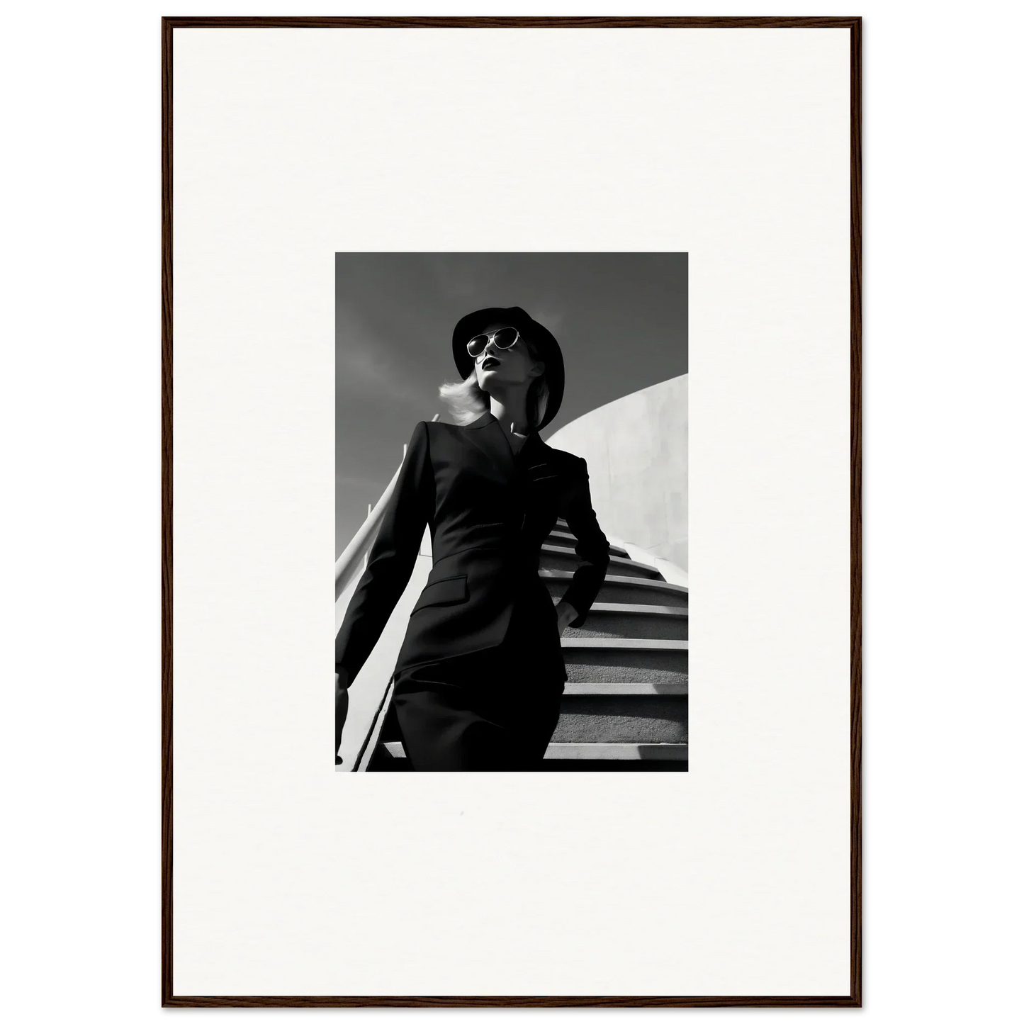 Black and white photograph of a stylishly dressed person on stairs.
