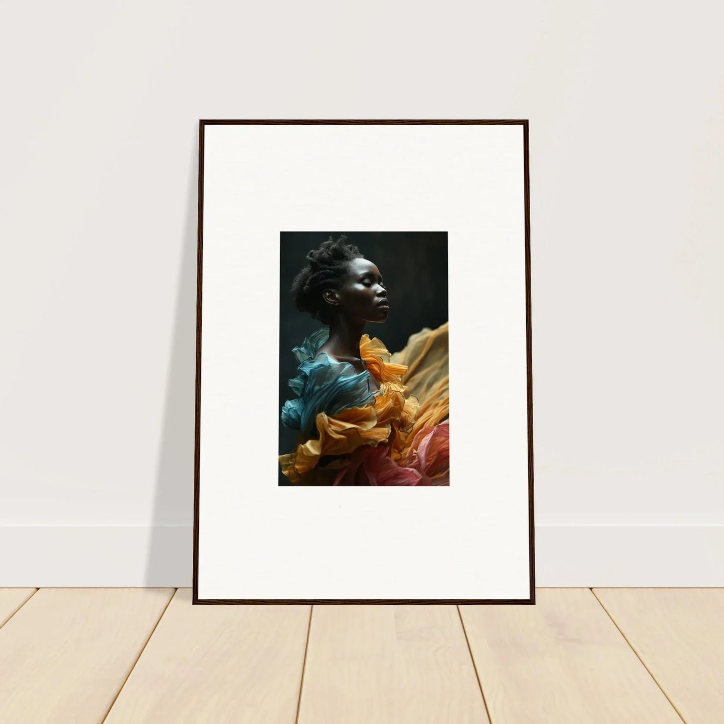 Framed portrait photograph of a person surrounded by vibrant, colorful fabric.