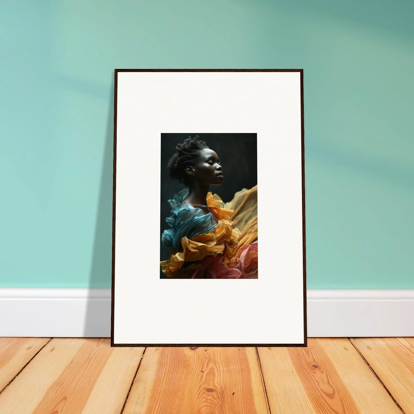 Framed artwork featuring a portrait of a person surrounded by colorful, flowing fabric.