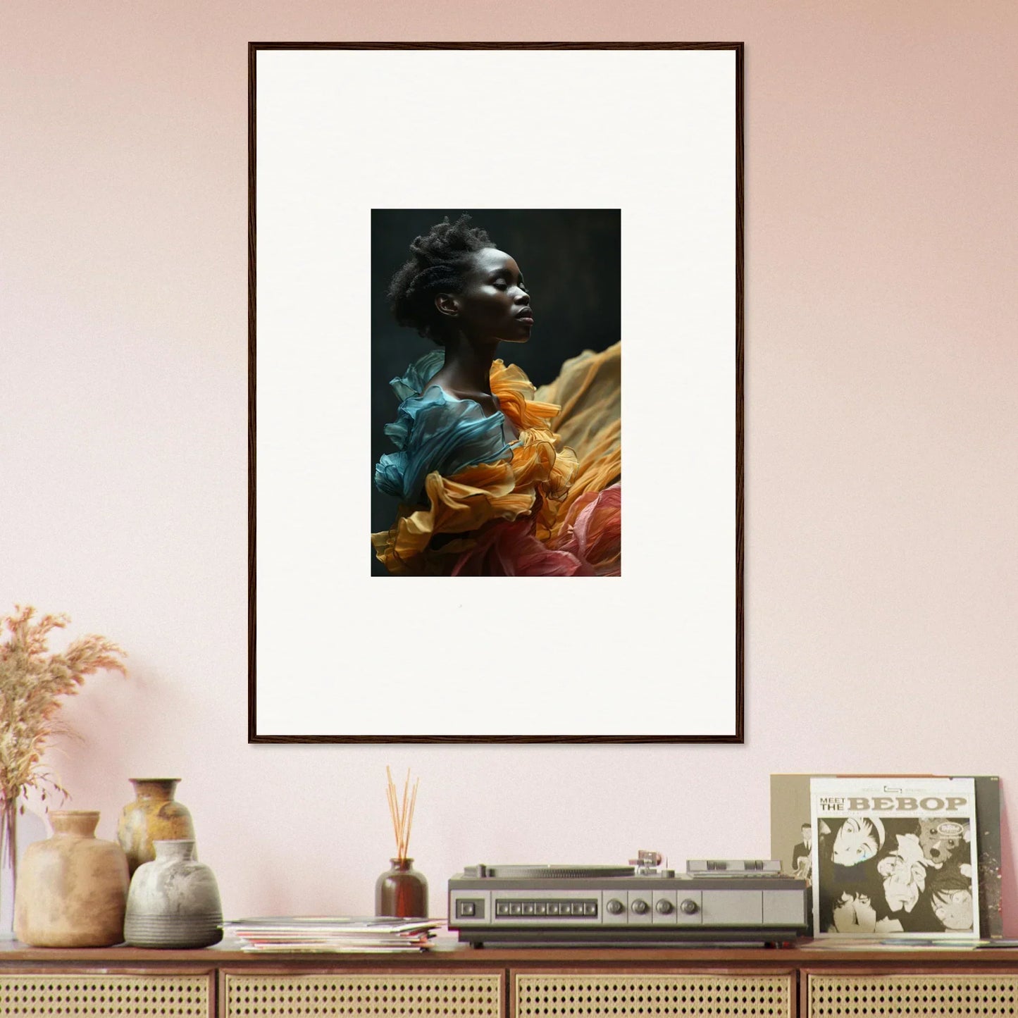 Framed portrait of a person surrounded by vibrant, colorful fabric.