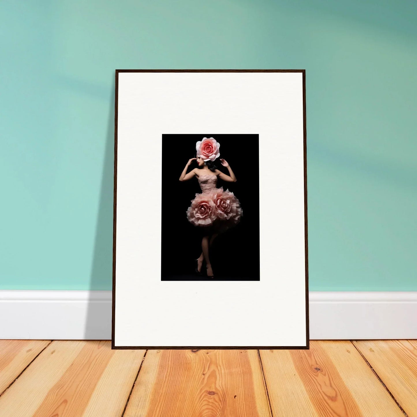 Framed artwork depicting a figure in a floral dress against a dark background.