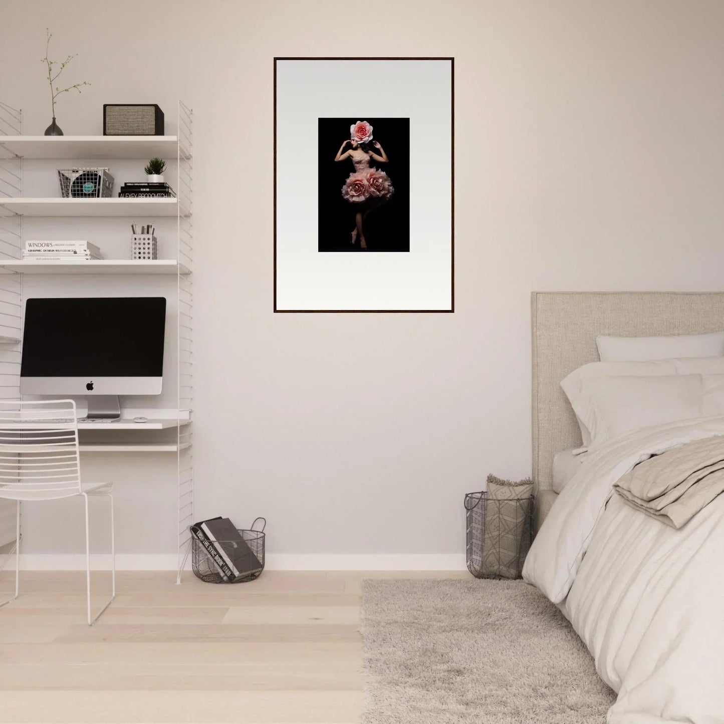 Framed artwork featuring a dark figure adorned with pink flowers.