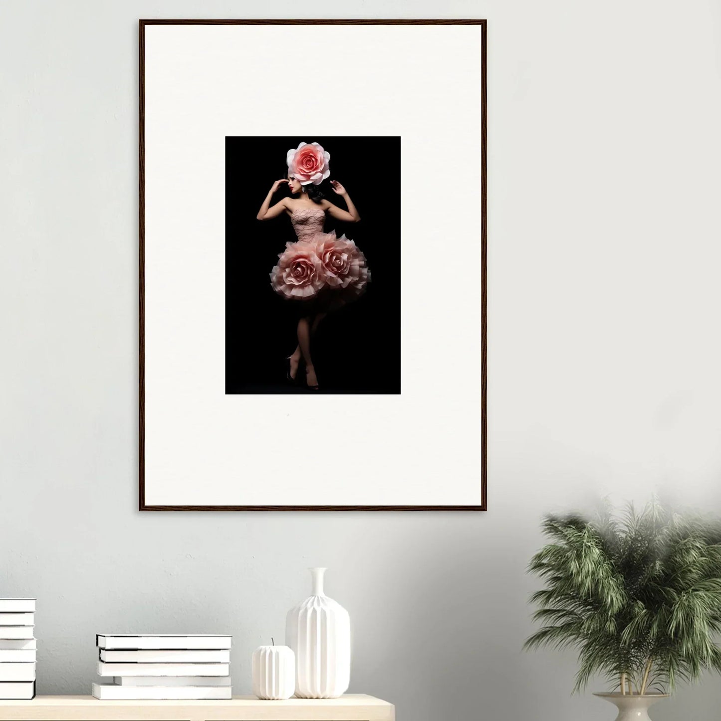 Framed artwork depicting a figure in a floral-inspired dress against a dark background.
