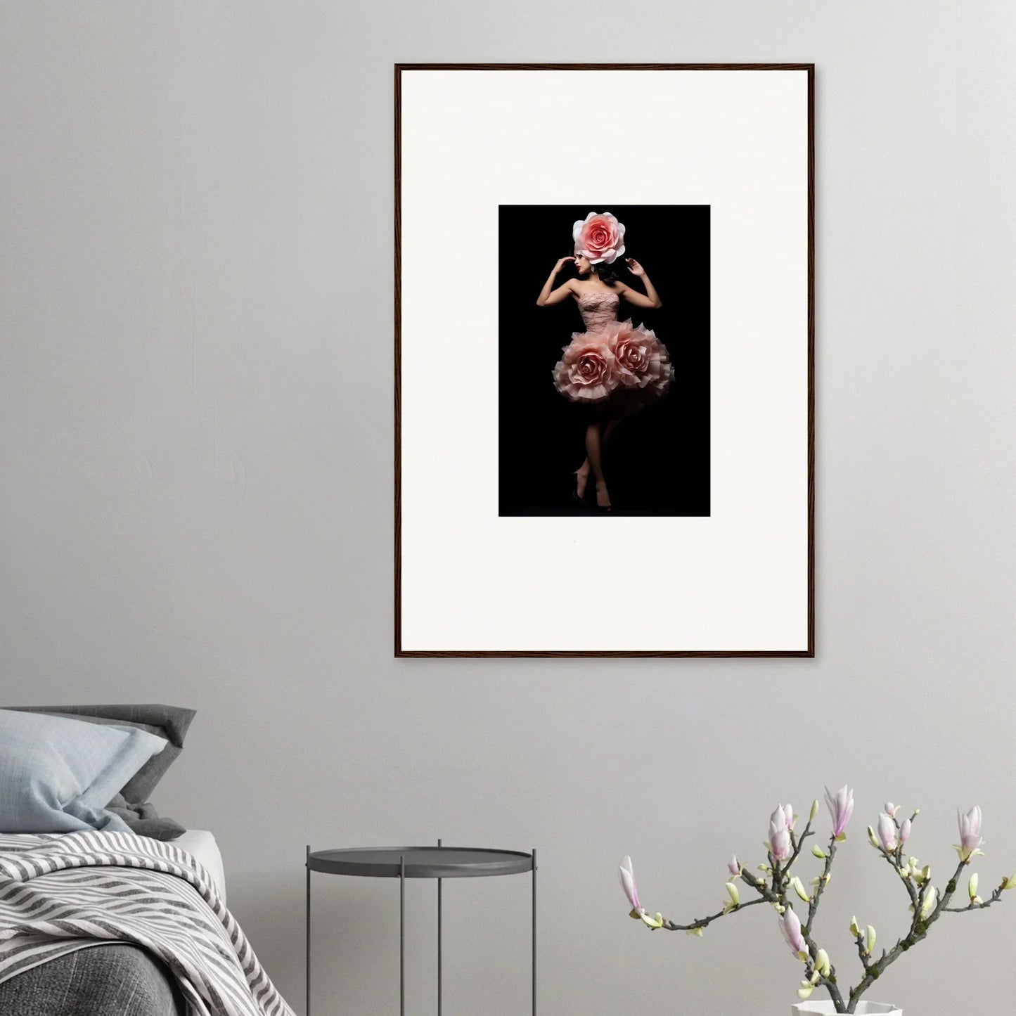 Framed artwork depicting a figure wearing an elaborate floral-inspired costume against a dark background.