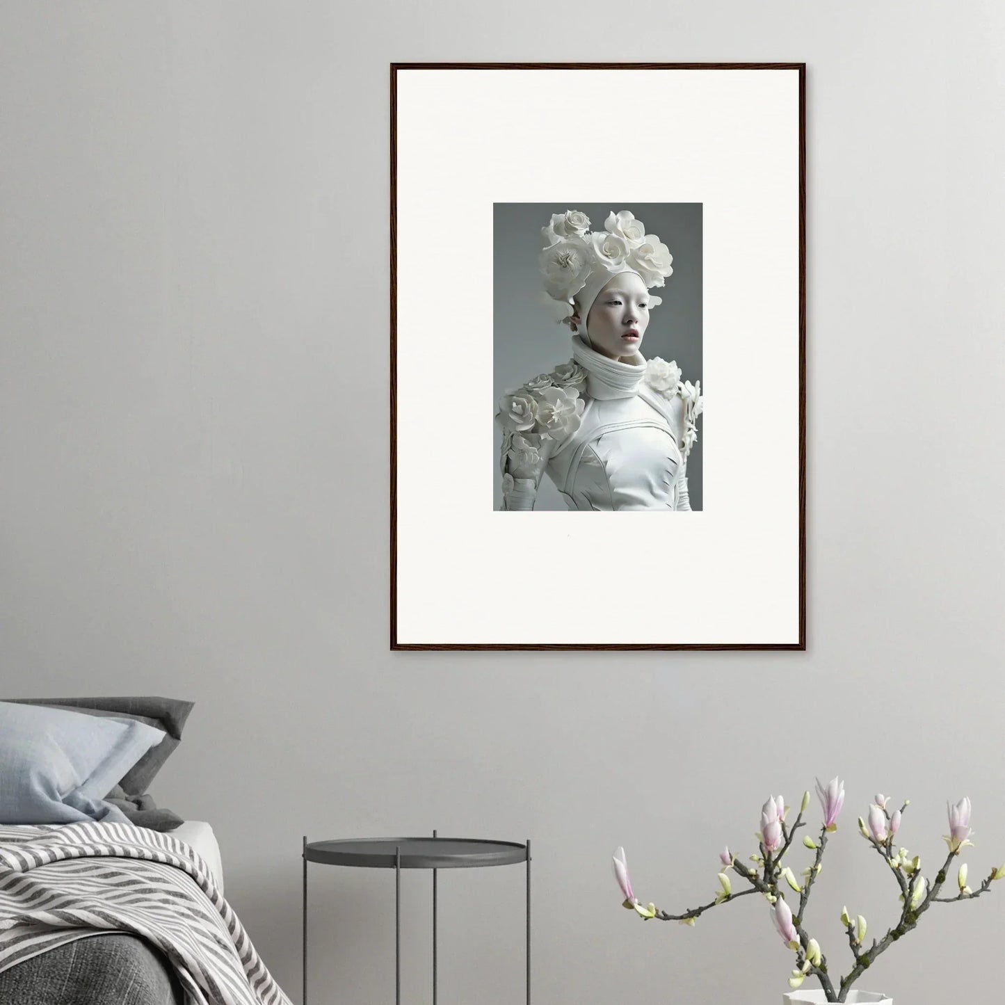 Framed black and white wall art of a figure with floral headdress for room decoration