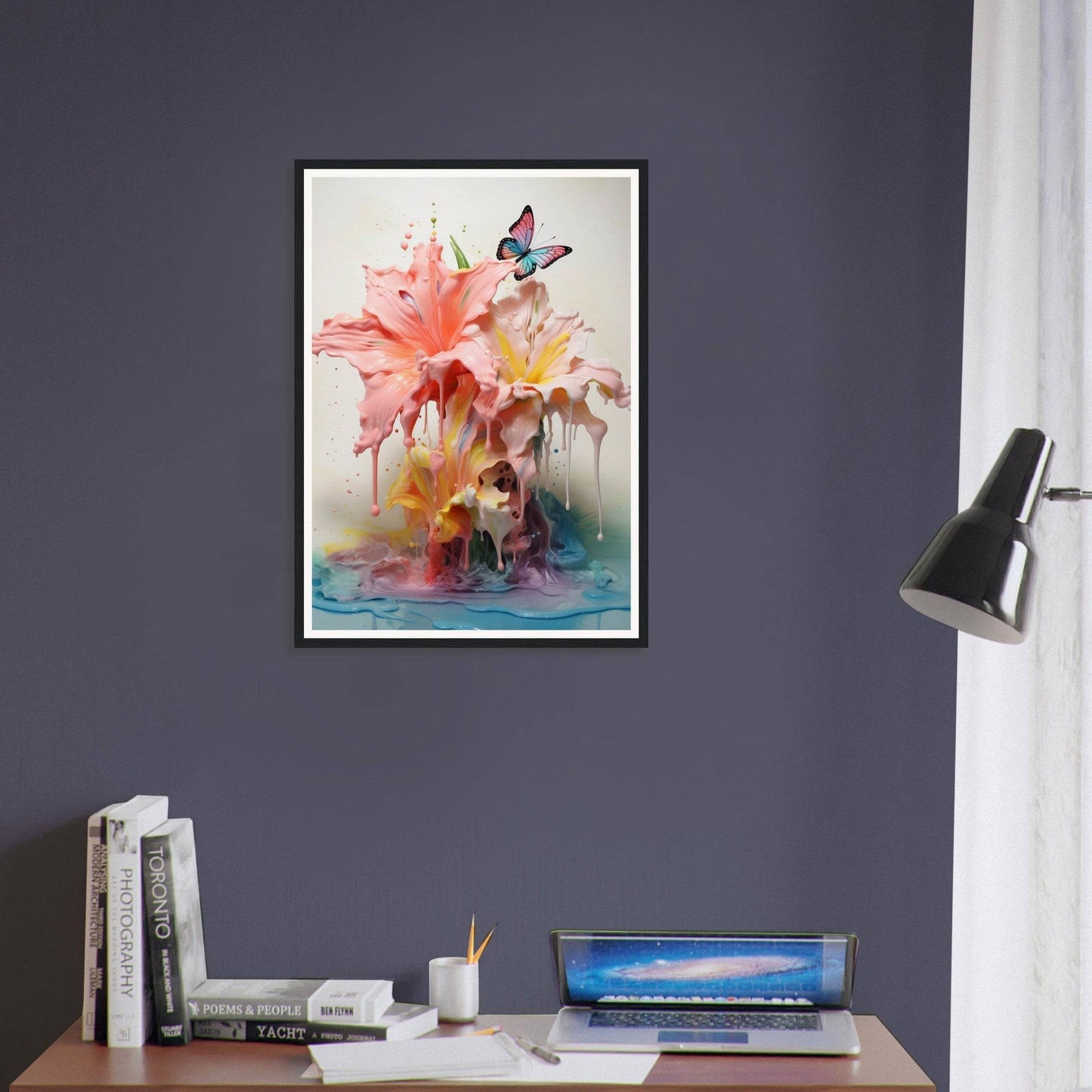 A framed print of a pink flower on a desk