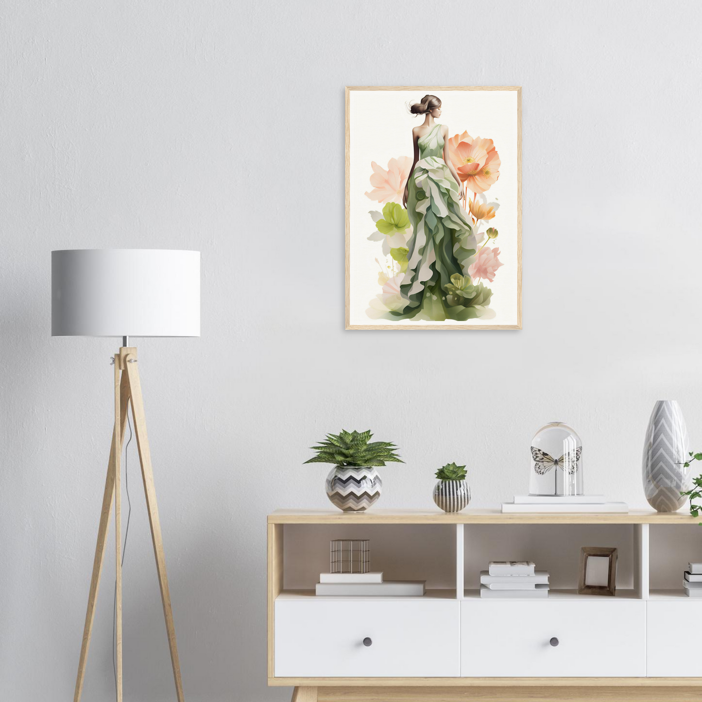 A framed print of a woman in a green dress with flowers