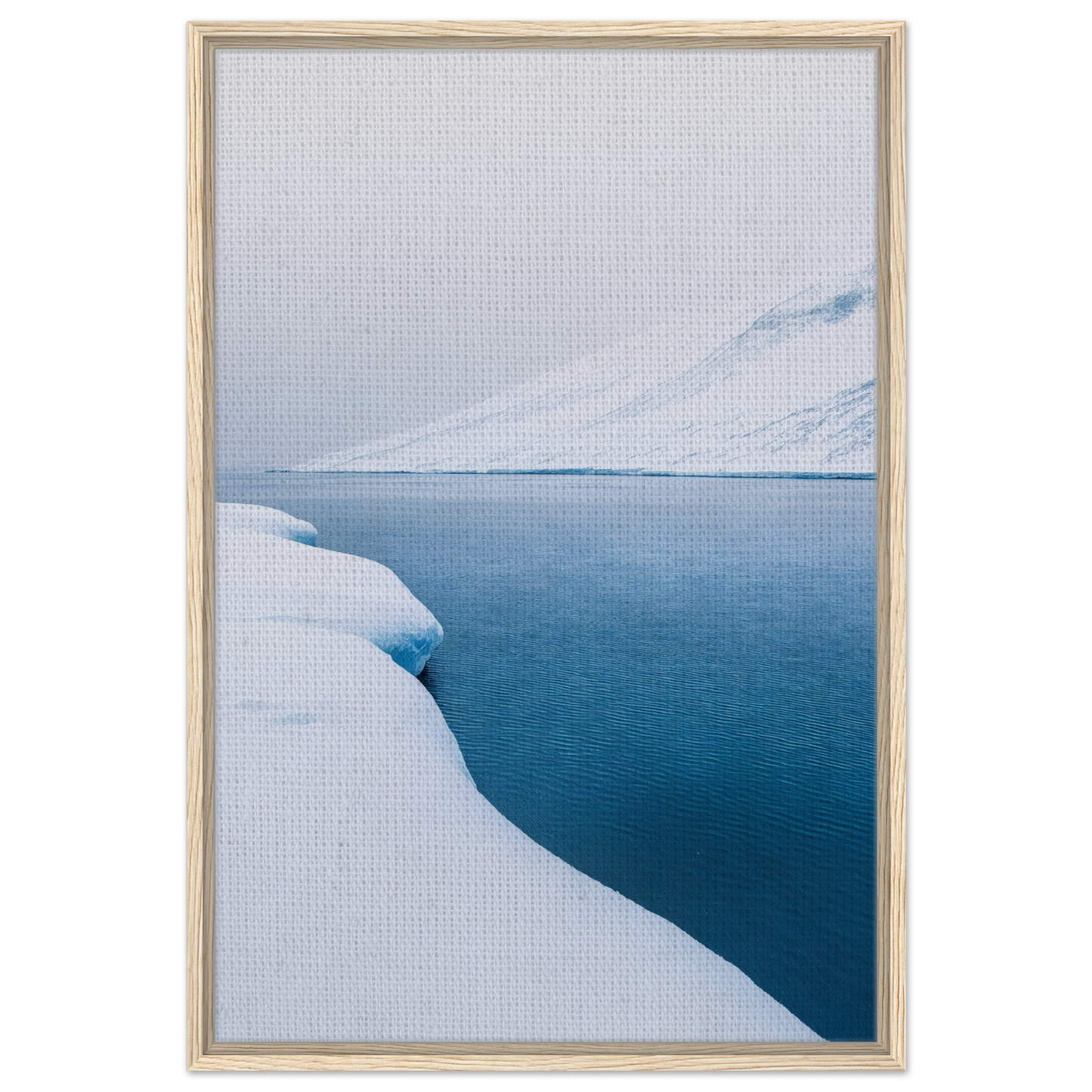Framed canvas print of a snowy landscape and calm blue water from Frozen Serenity Echoes