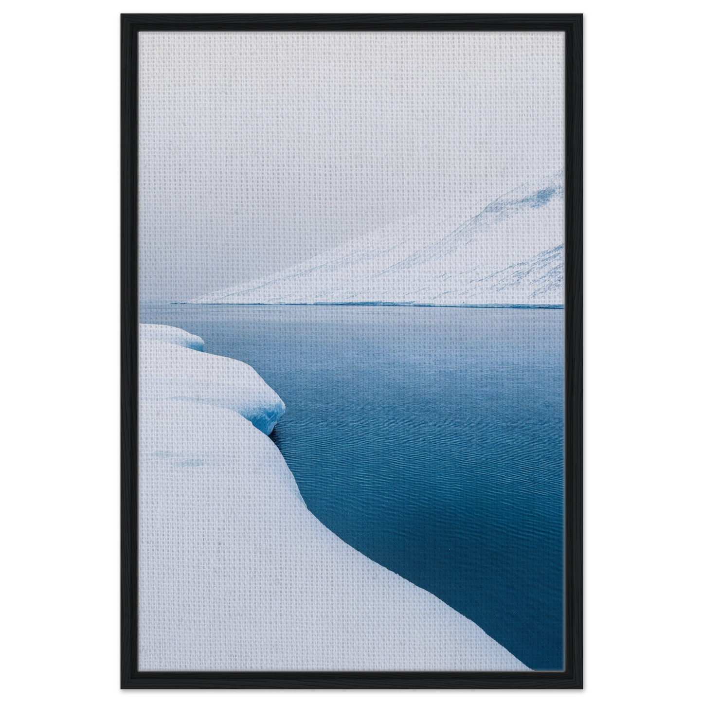 Framed canvas print of Frozen Serenity Echoes featuring a snowy landscape and deep blue water