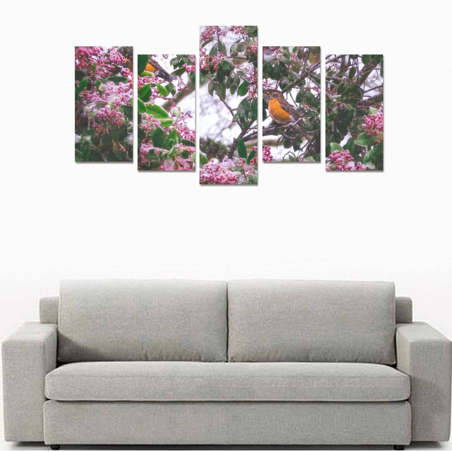 Light gray sofa positioned beneath a multi-panel nature artwork featuring flowers and a bird.