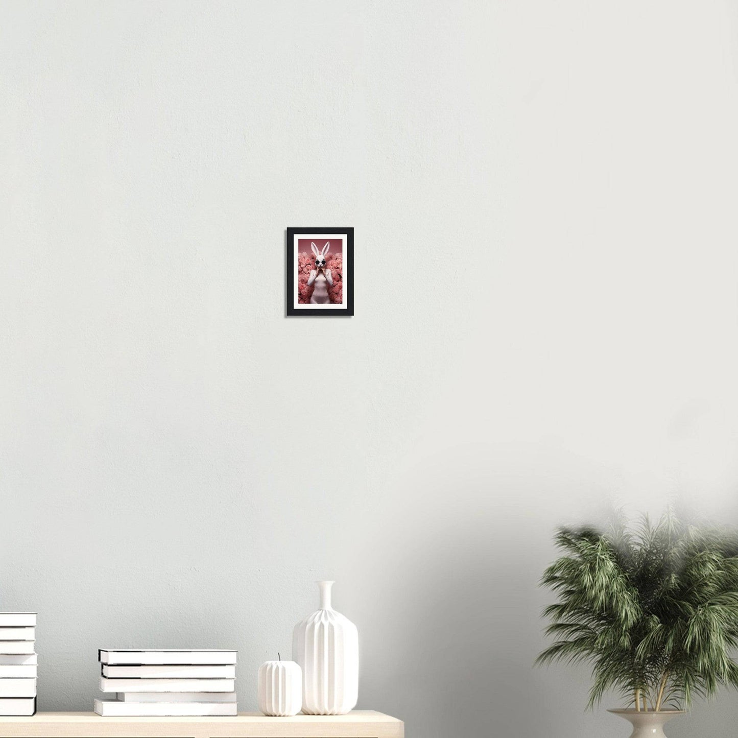 Framed artwork featuring a stylized pink and red butterfly design.