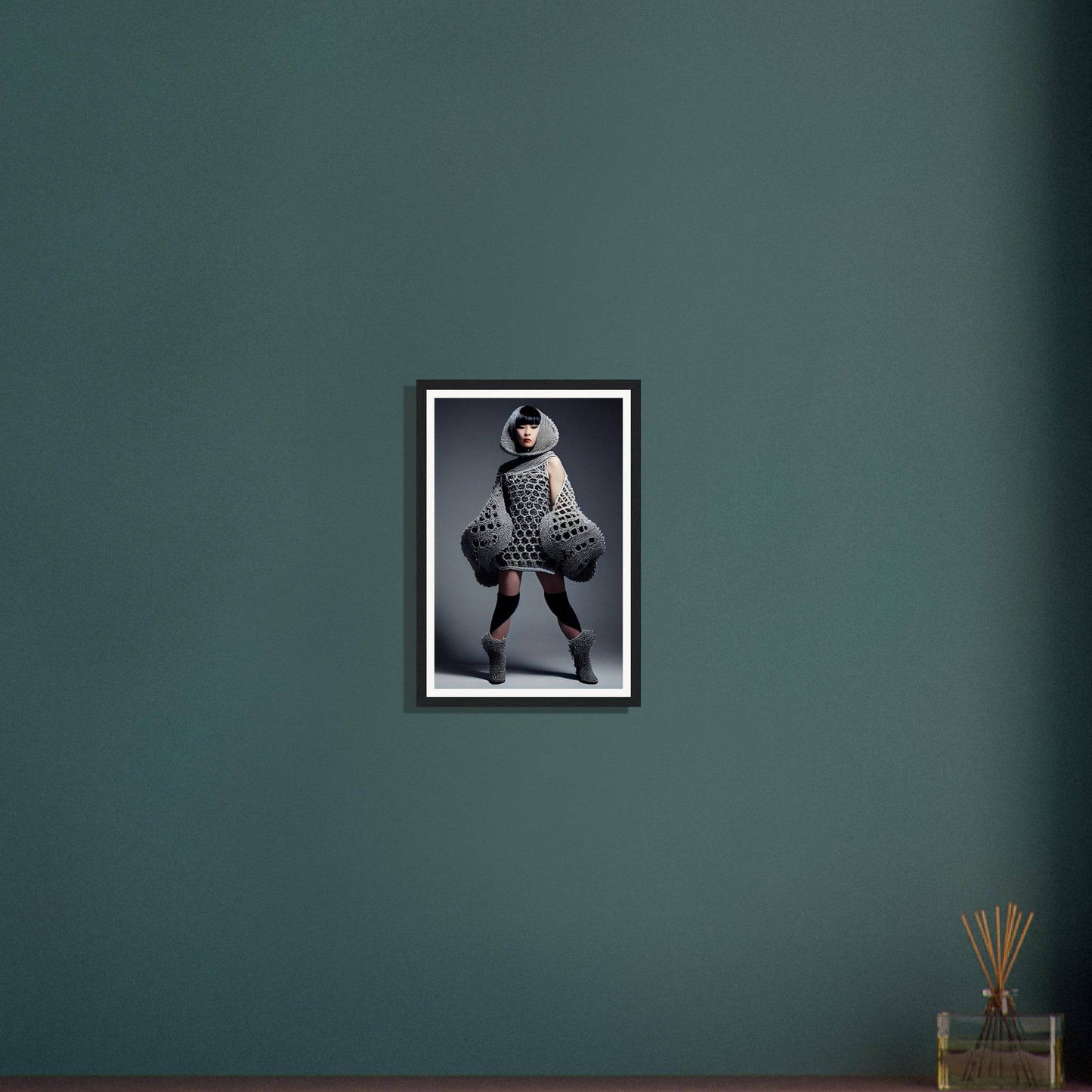 Framed black-and-white photograph of a person in an avant-garde outfit posing dramatically.