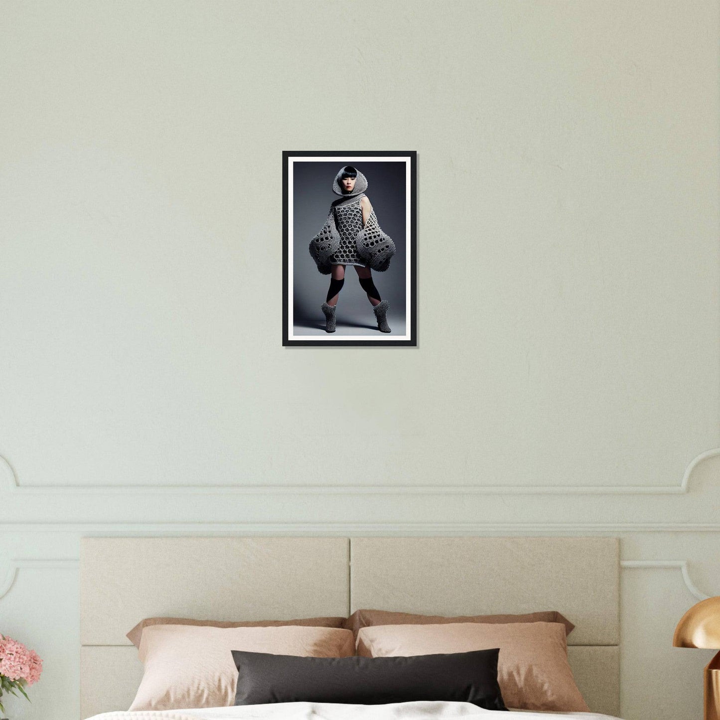 Framed black-and-white photograph of a person in an avant-garde, puffy outfit posing dramatically.