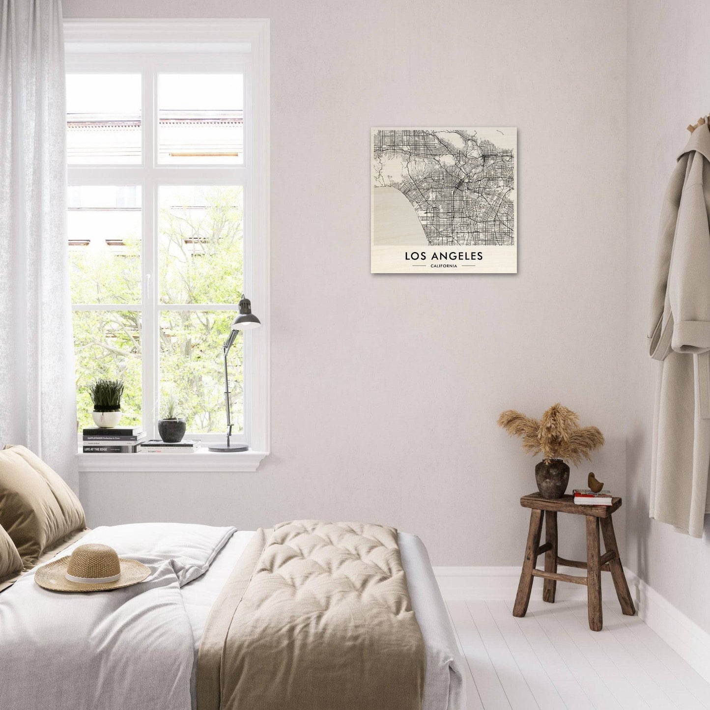 Bright, airy bedroom with minimalist decor and a Los Angeles map on the wall.