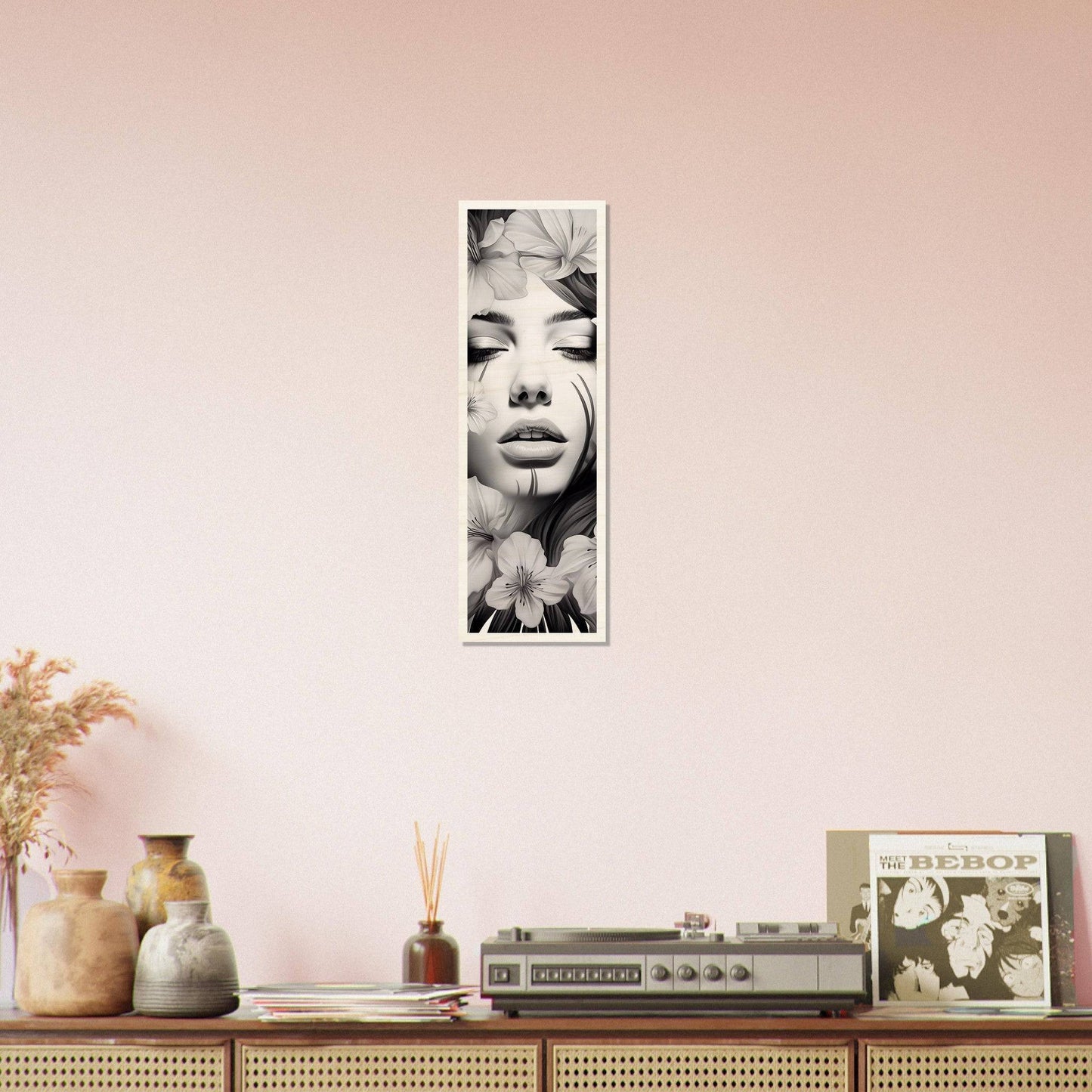 Vertical black and white portrait photograph mounted on a pale wall.