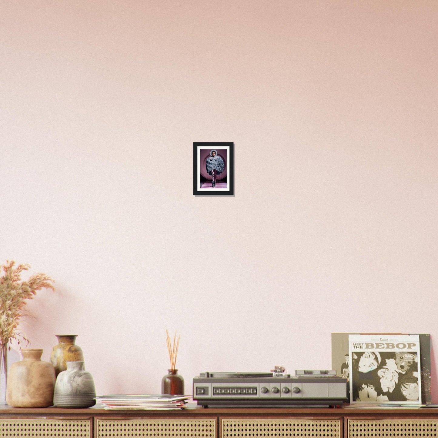 Vintage stereo receiver or amplifier on a wooden console, accompanied by decorative items like vases, a framed picture, and a vinyl record.