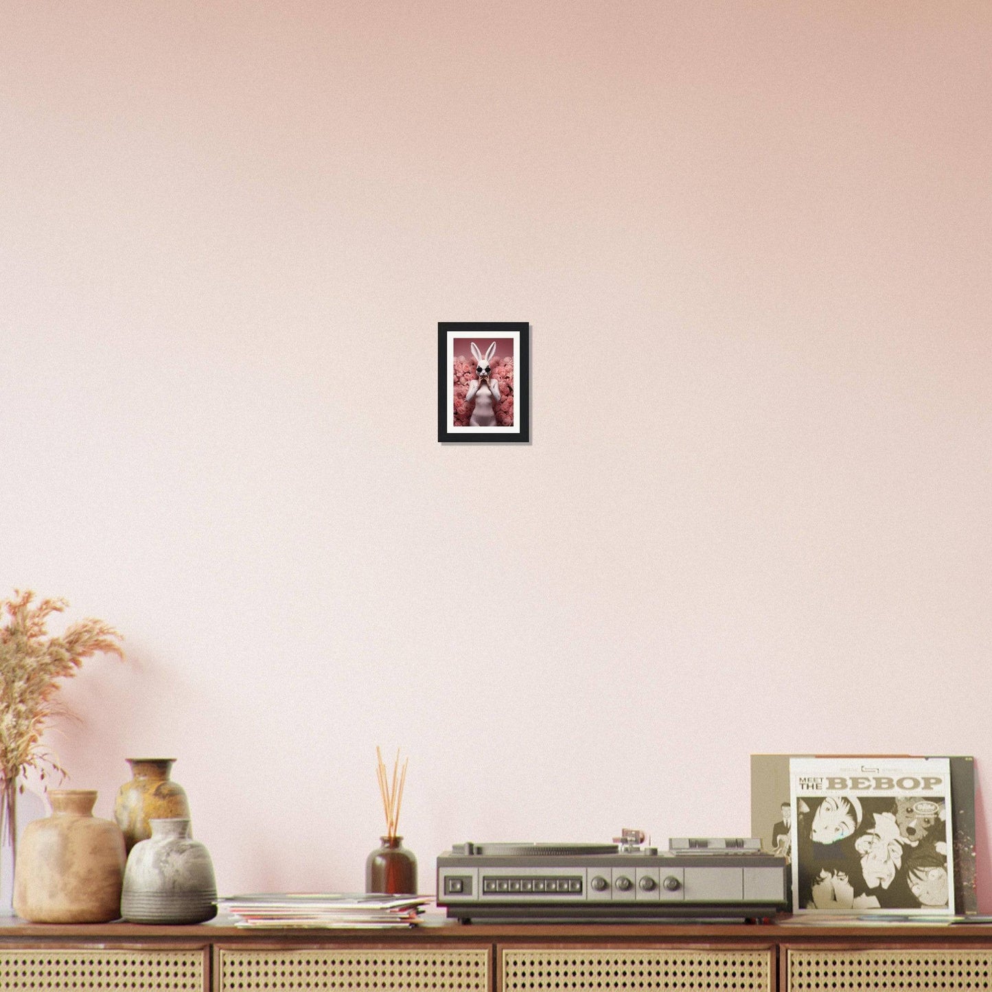 Wooden sideboard or console table with decorative items displayed on top, including vases, a framed picture, and electronic equipment.