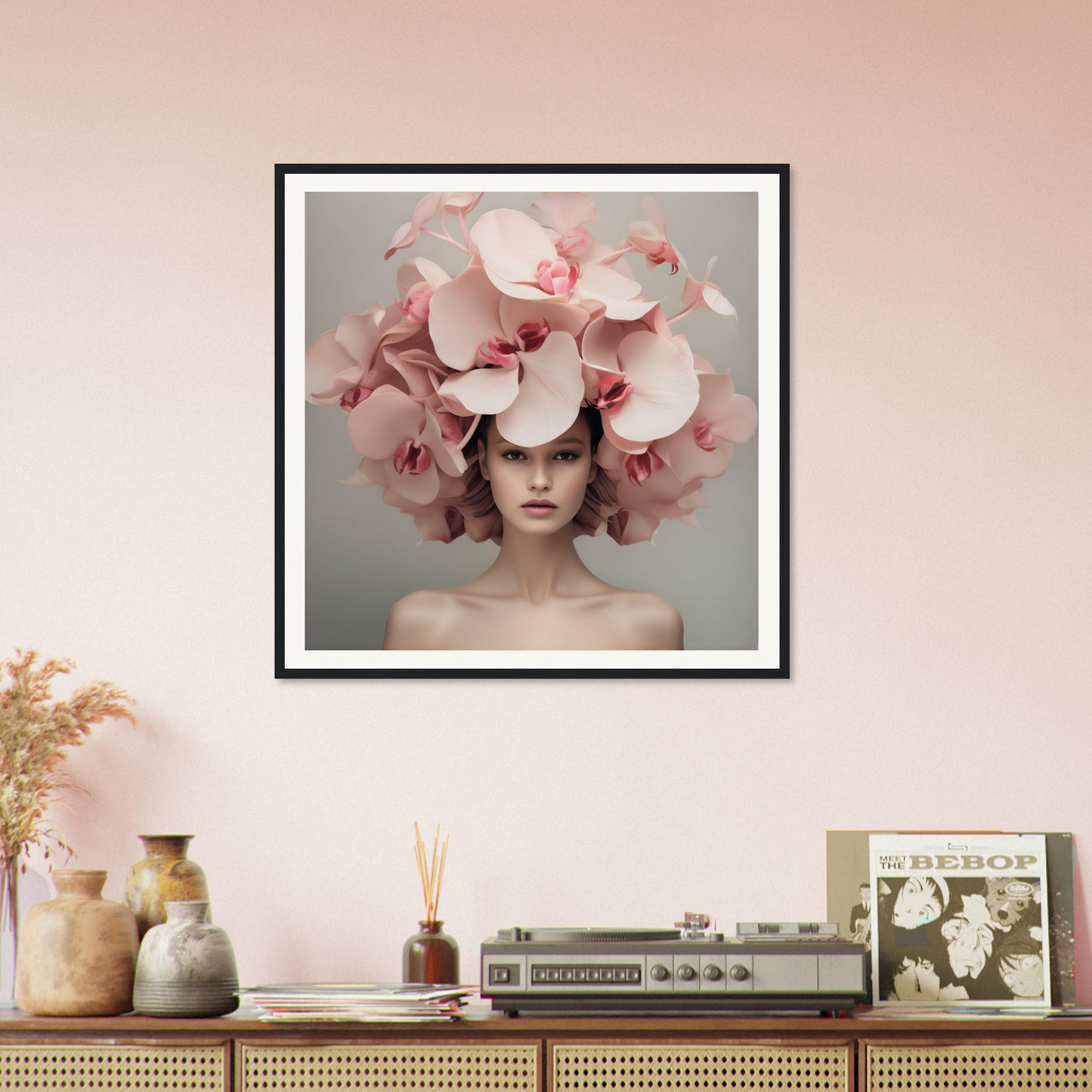 Framed portrait of a person wearing an elaborate floral headdress made of pink orchids.
