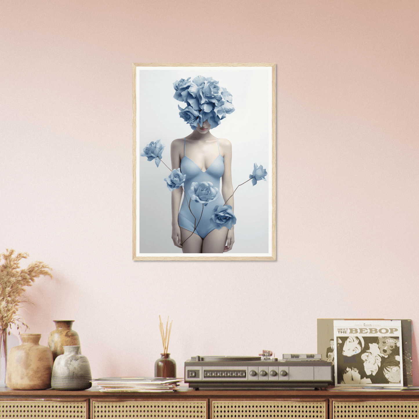 Framed artwork depicting a figure with blue floral elements in place of a head and hands.