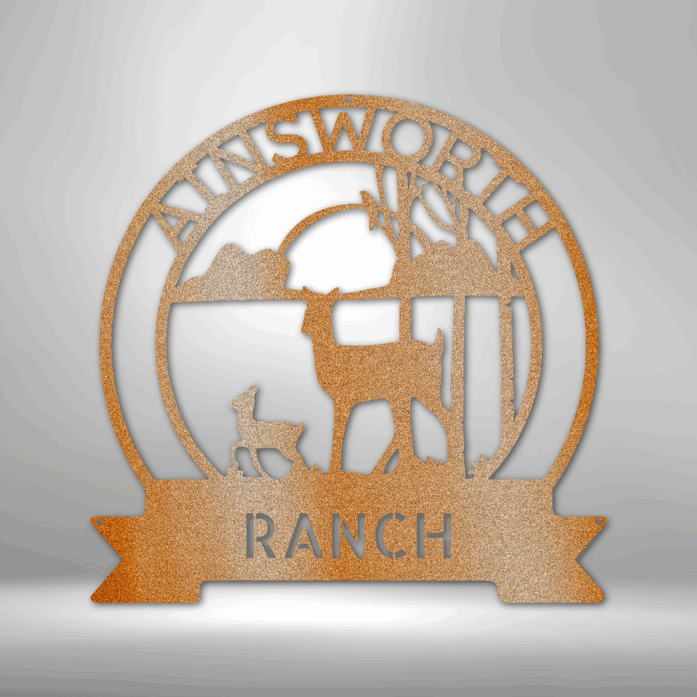 Circular metal sign featuring a ranch scene with deer silhouettes and the text ’AINSWORTH RANCH’.