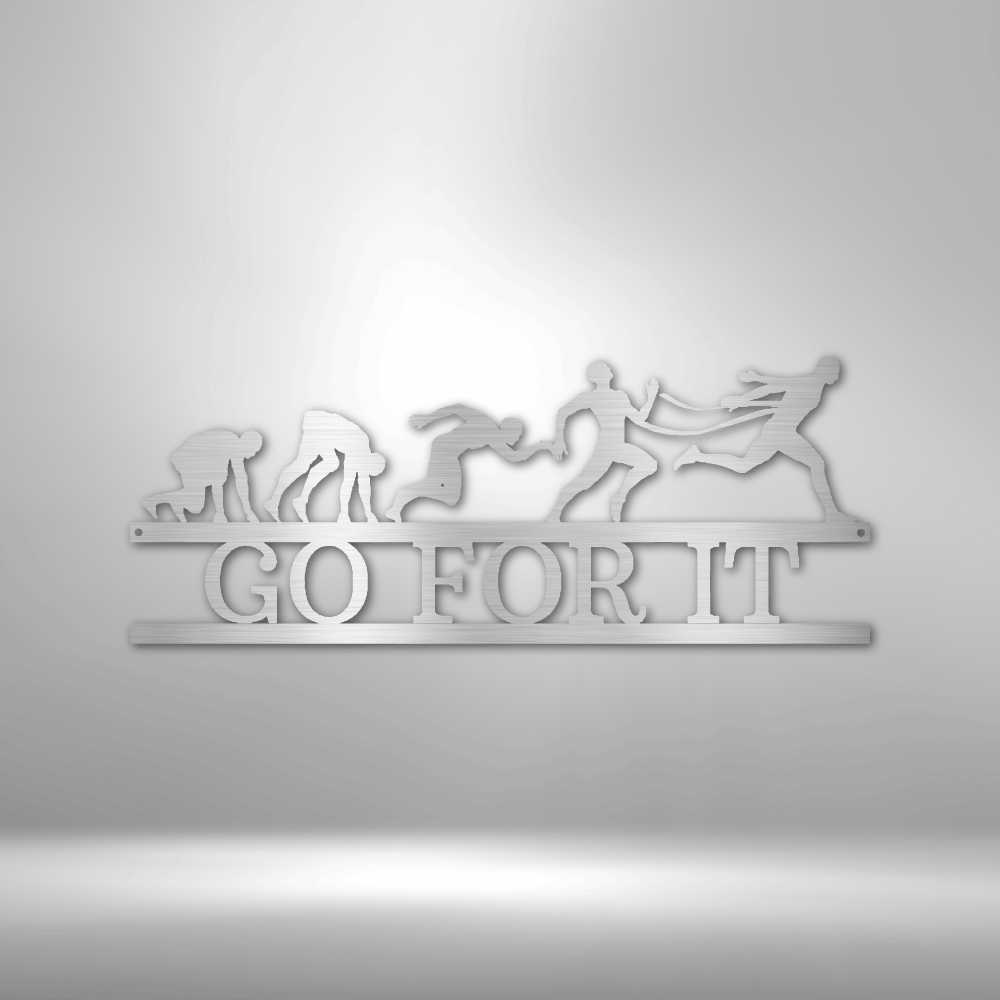 Motivational wall art depicting human evolution with the phrase ’GO FOR IT’ underneath.