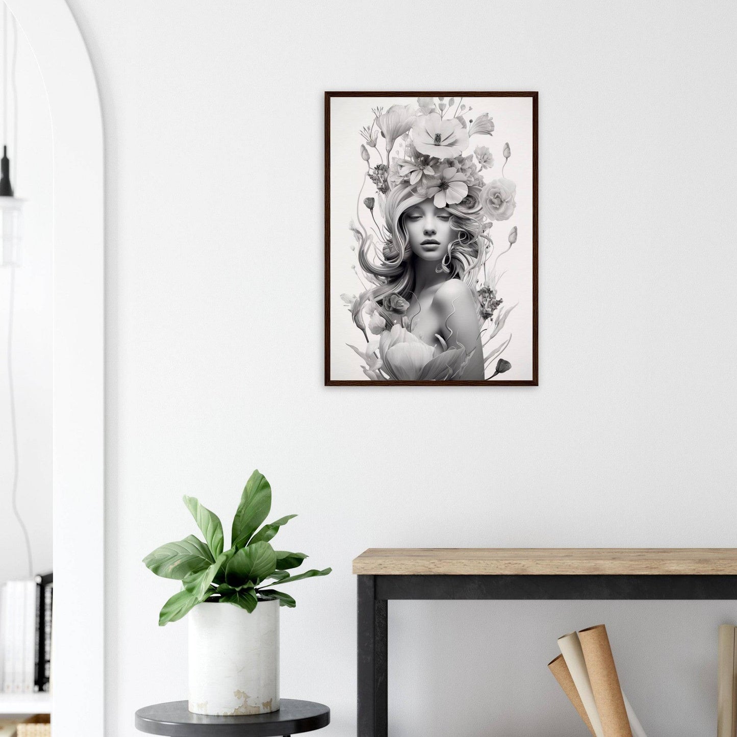 Framed black and white portrait of a woman with an elaborate floral headdress.