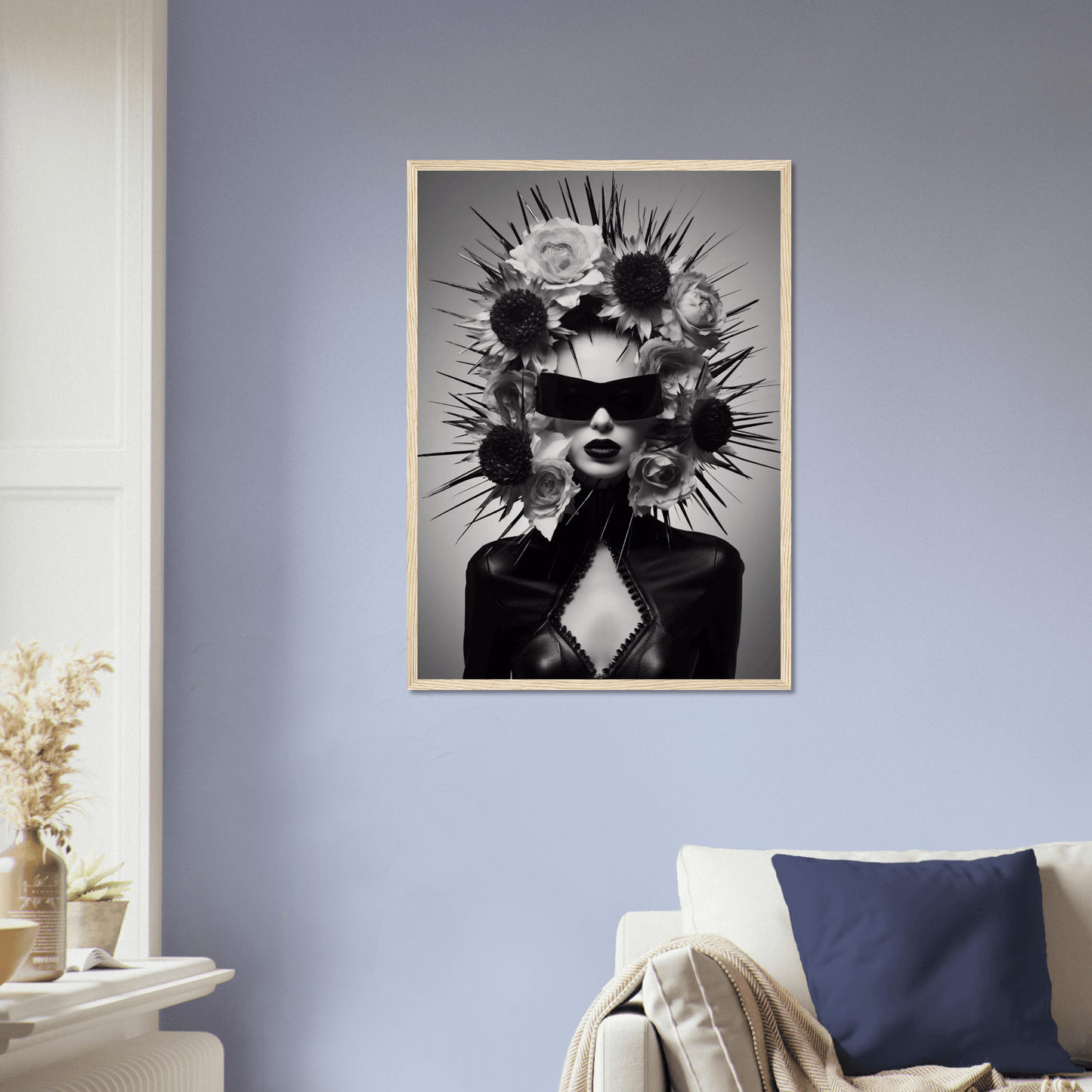 Striking black and white portrait of a figure wearing sunglasses and an elaborate spiked headdress adorned with flowers.