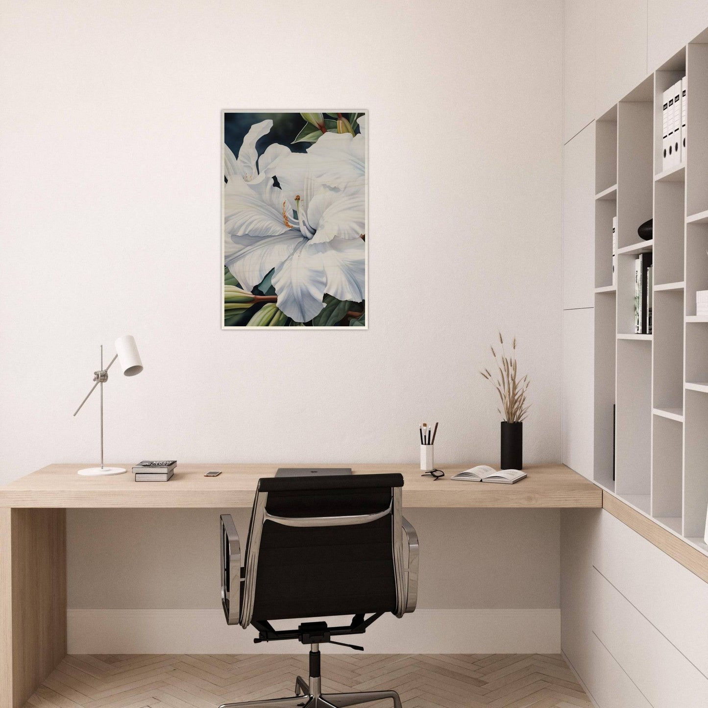 Minimalist home office workspace with a wooden desk, black office chair, and floral wall art.