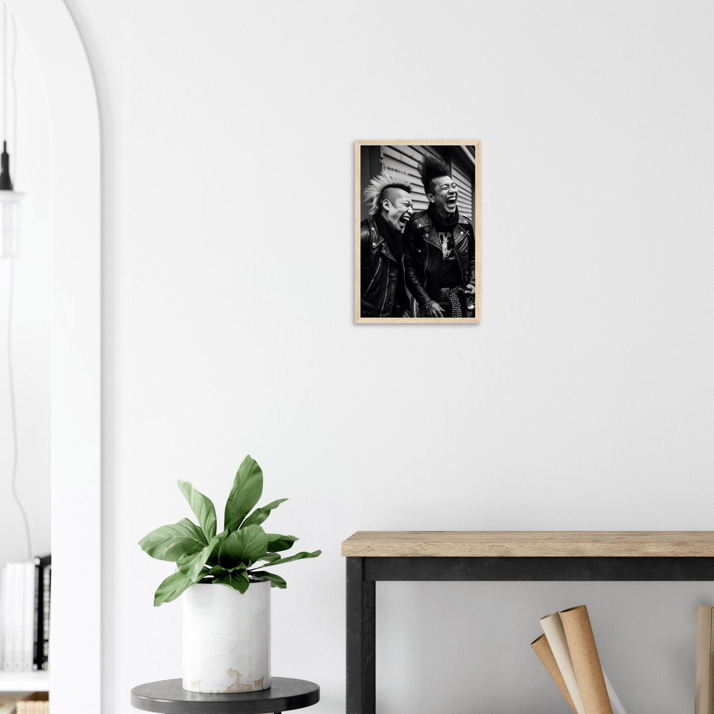 Framed black and white photograph of two people hanging on a white wall.