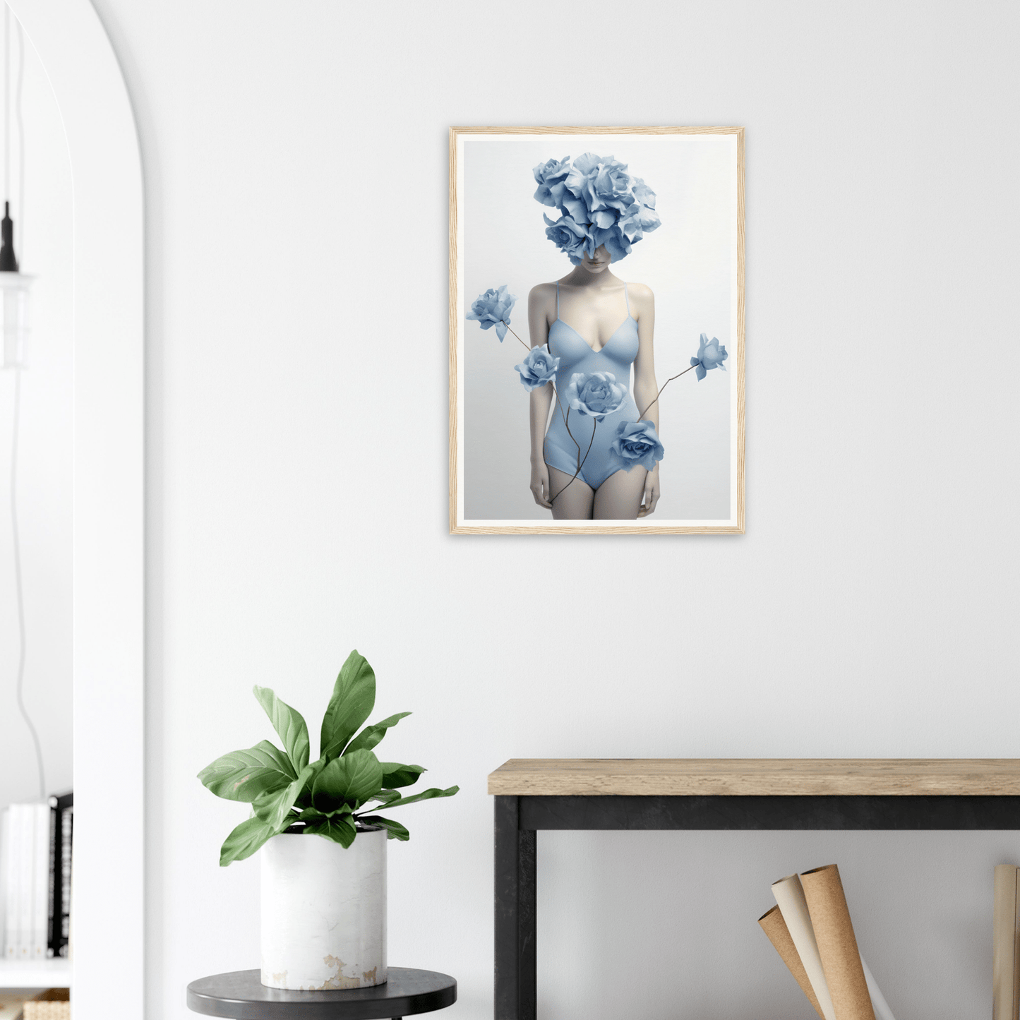 Framed artwork depicting a surreal figure with blue floral elements replacing the head and adorning the body.