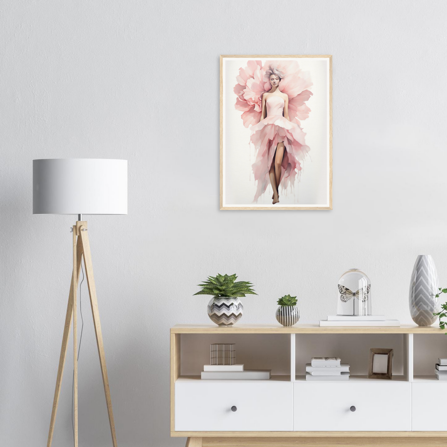 A pink flower in a white frame on a wall