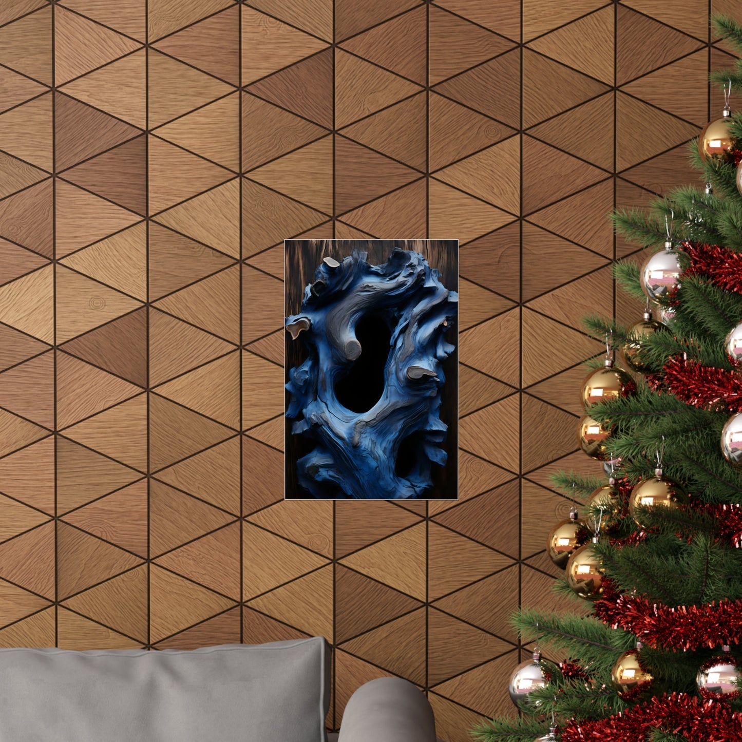 Geometric wood paneled wall with a blue abstract artwork and partial Christmas tree visible.