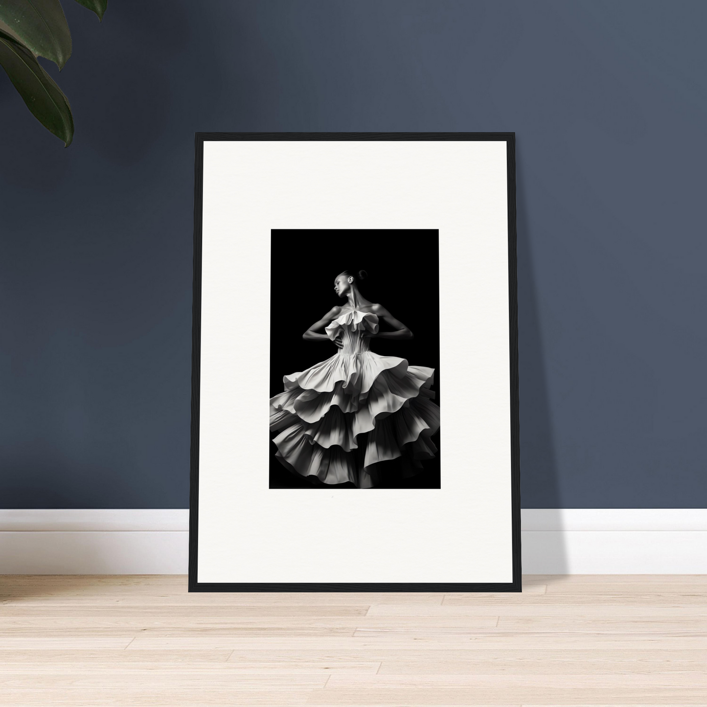 Framed black and white photograph of a dancer in a flowing, ruffled dress.