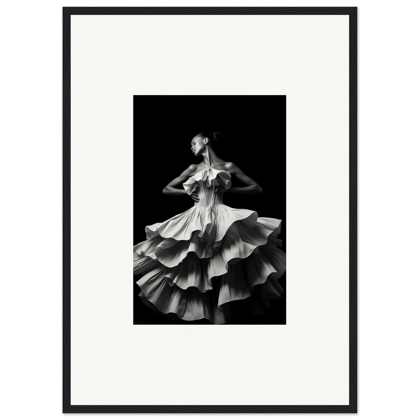 Black and white photograph of a dancer in a flowing, multi-tiered dress.