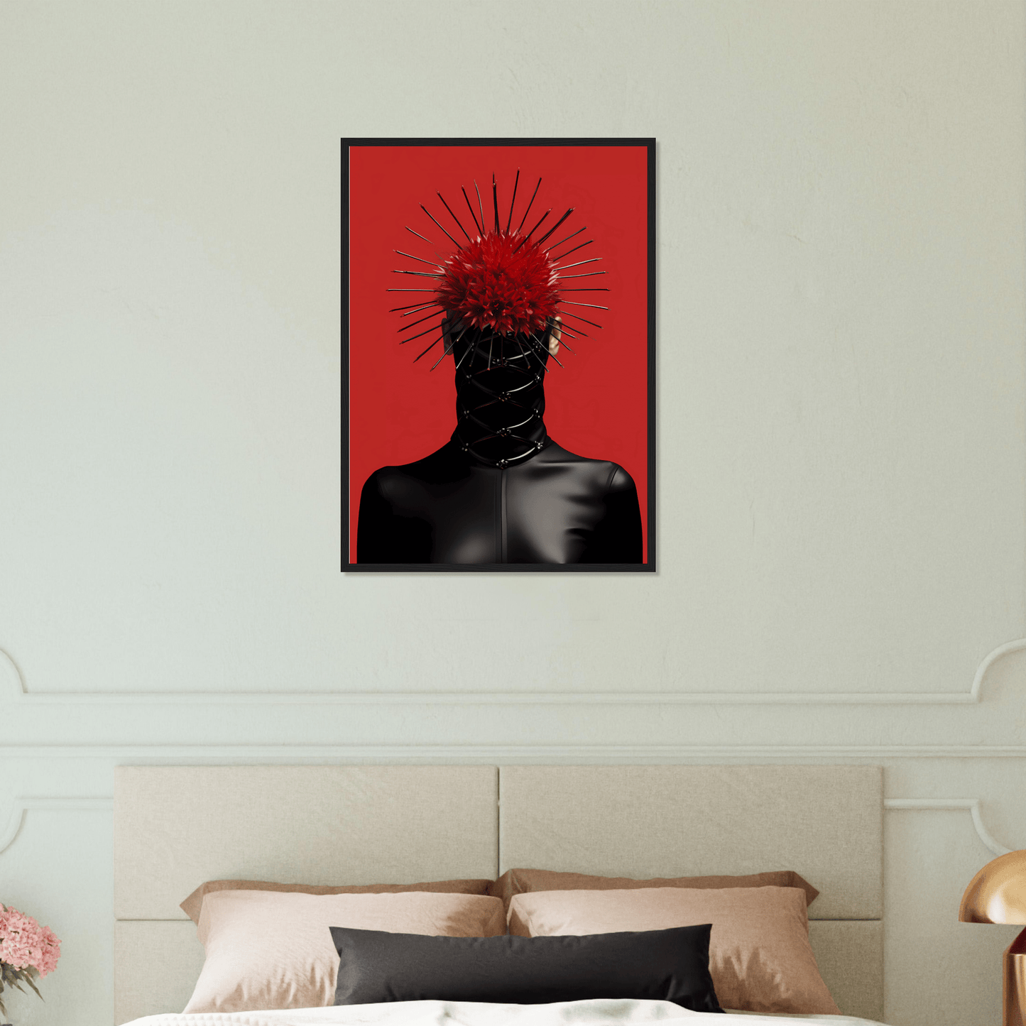 A red and black painting on a wall above a bed