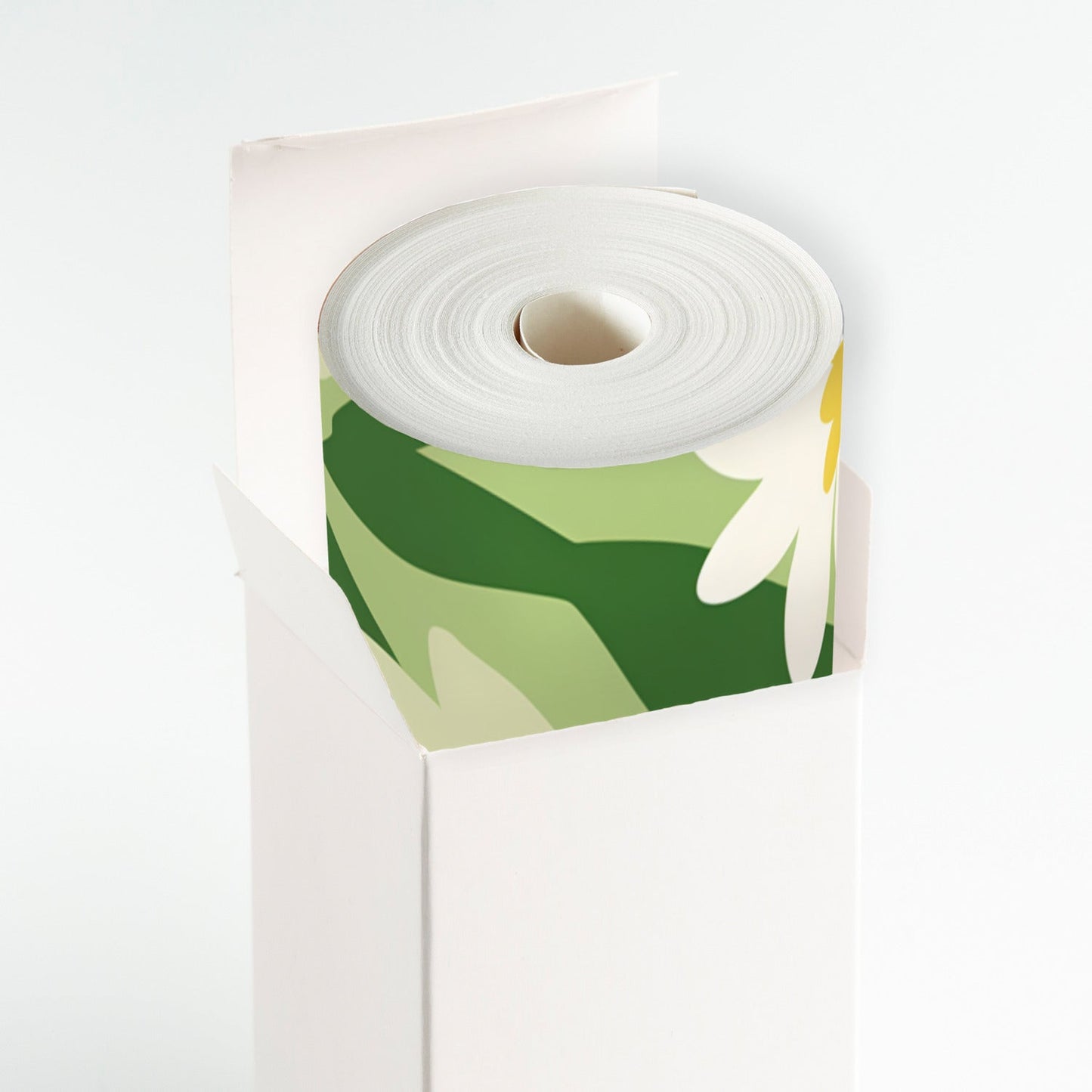 A roll of white paper with a green and yellow flower on it