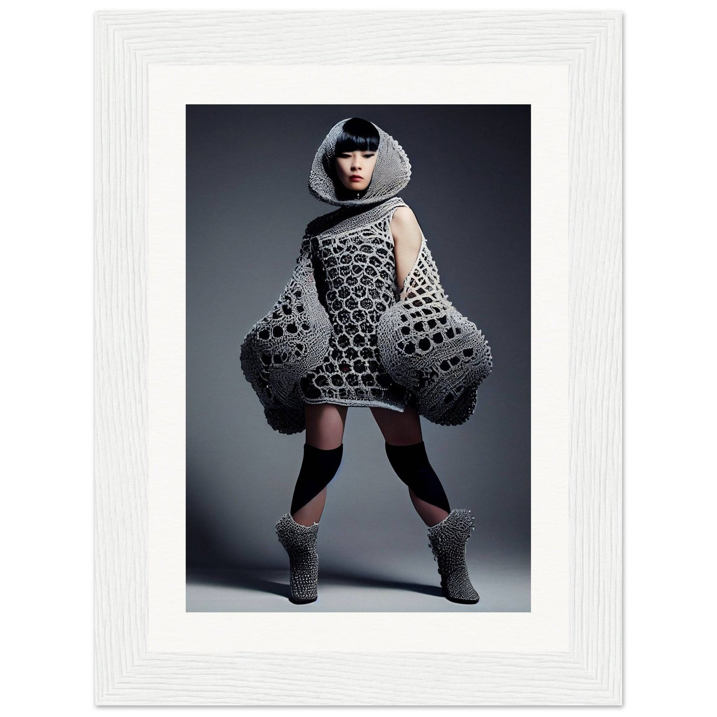 Avant-garde knitted dress with exaggerated voluminous sleeves and a hooded neckline.