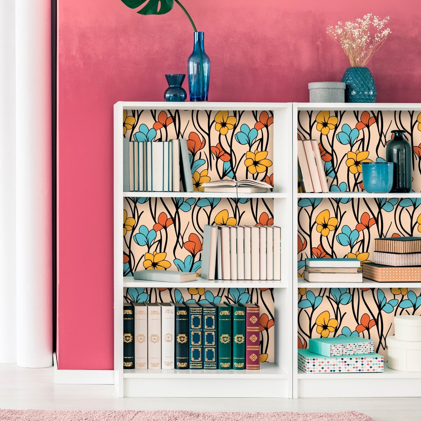 Bookshelf with colorful floral patterned backing and various decorative objects.