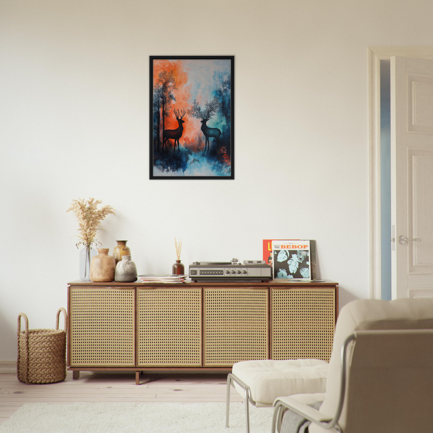 Wooden Stag Symphony sideboard with cane-webbed doors and decorative framed wall art