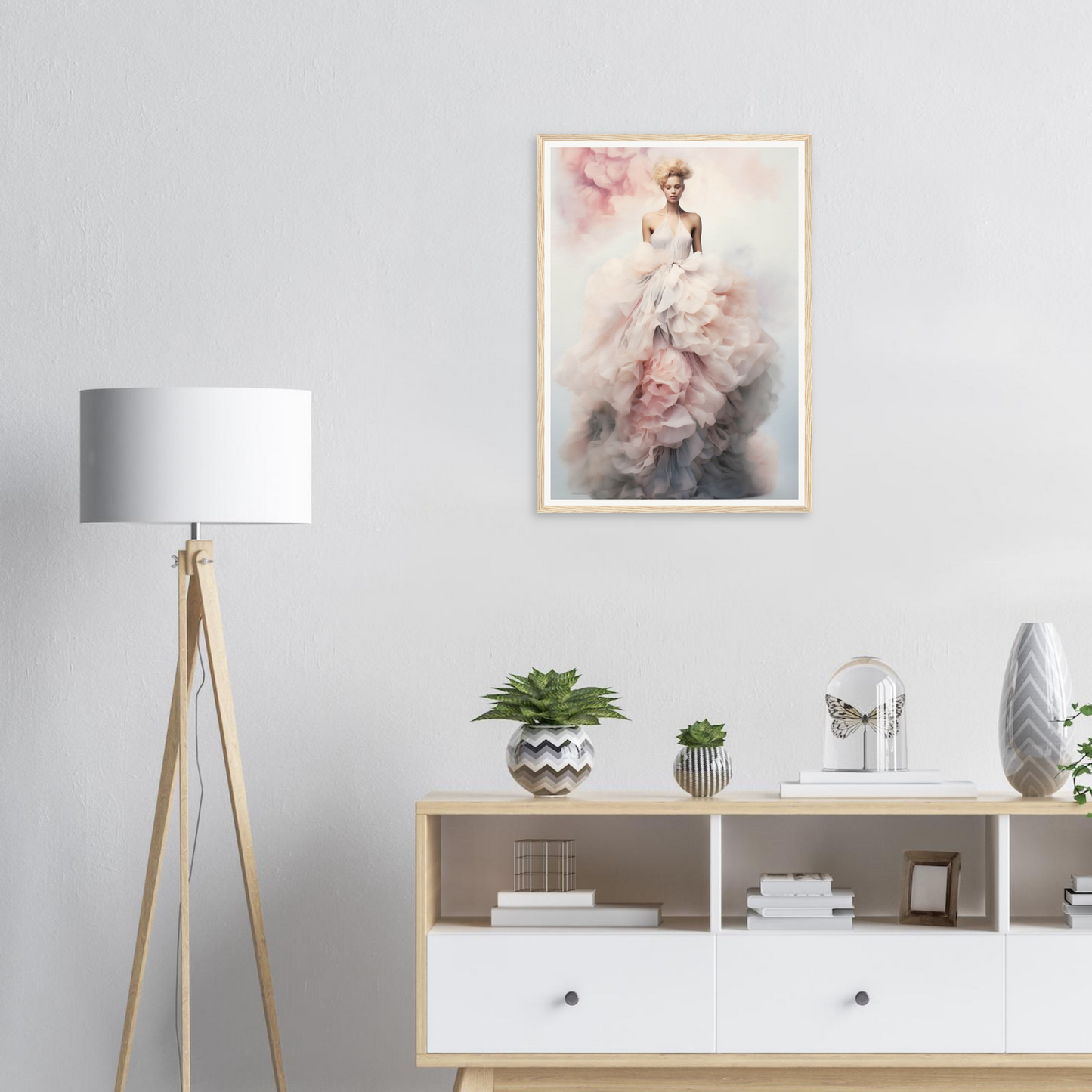 Framed artwork depicting an ethereal figure in a flowing white dress with pink accents.