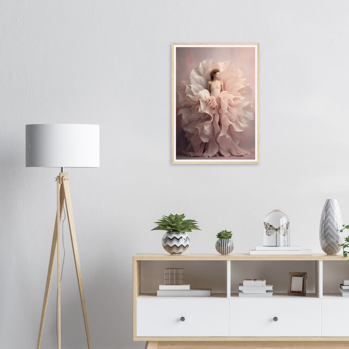 Framed artwork depicting a figure surrounded by flowing, ethereal fabric in soft pink tones.