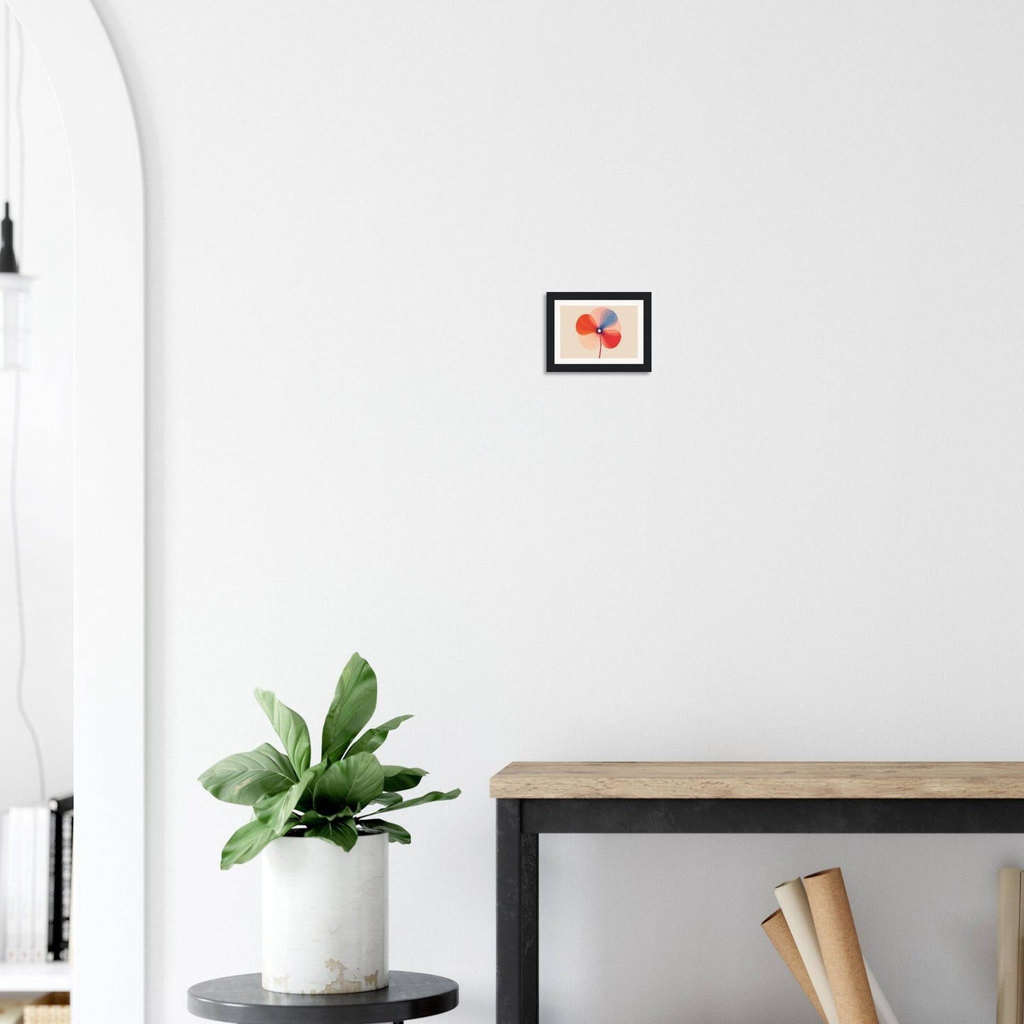 Framed artwork of red cherries hanging on a white wall.