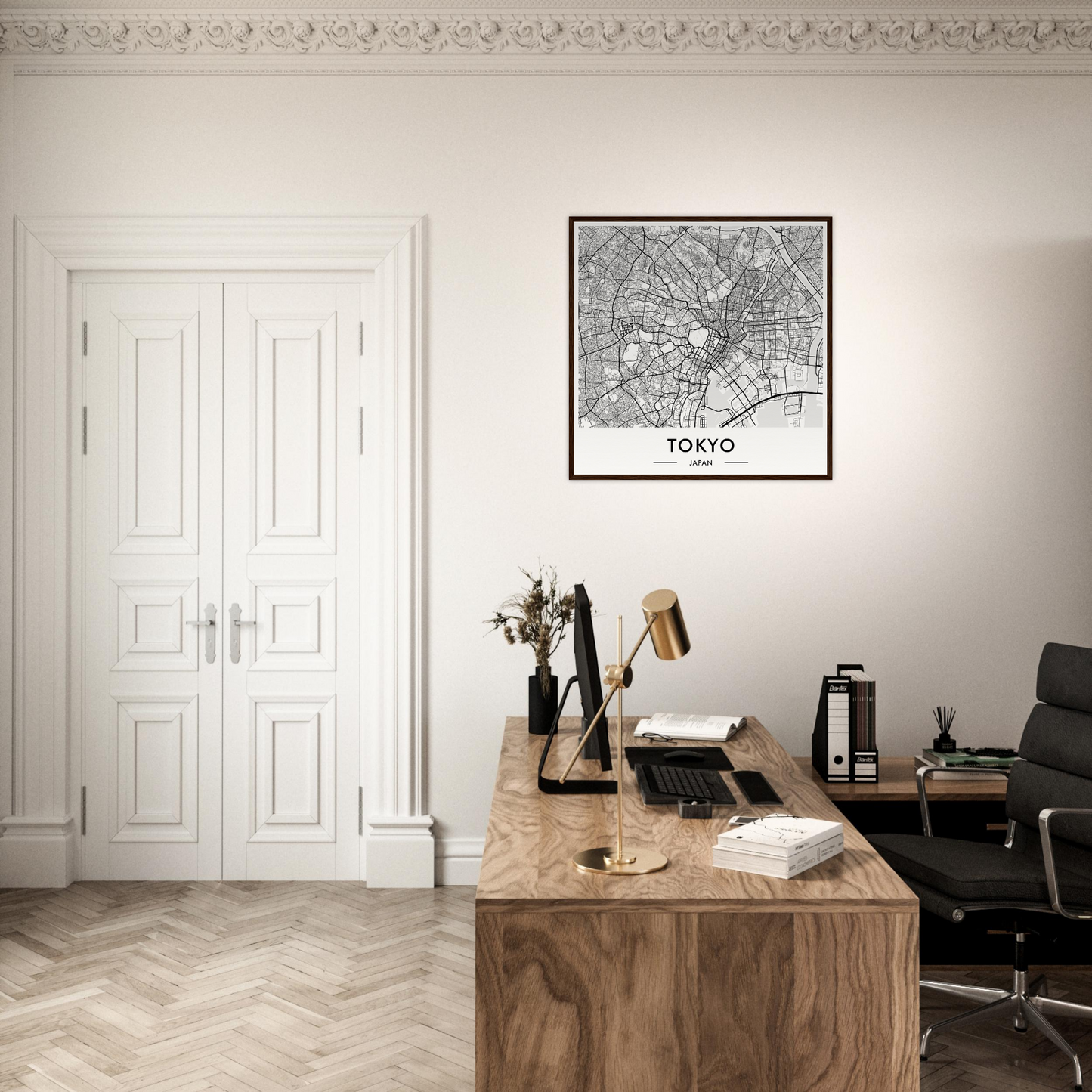 Wooden desk with various office supplies and a framed map of Tokyo on the wall above it.