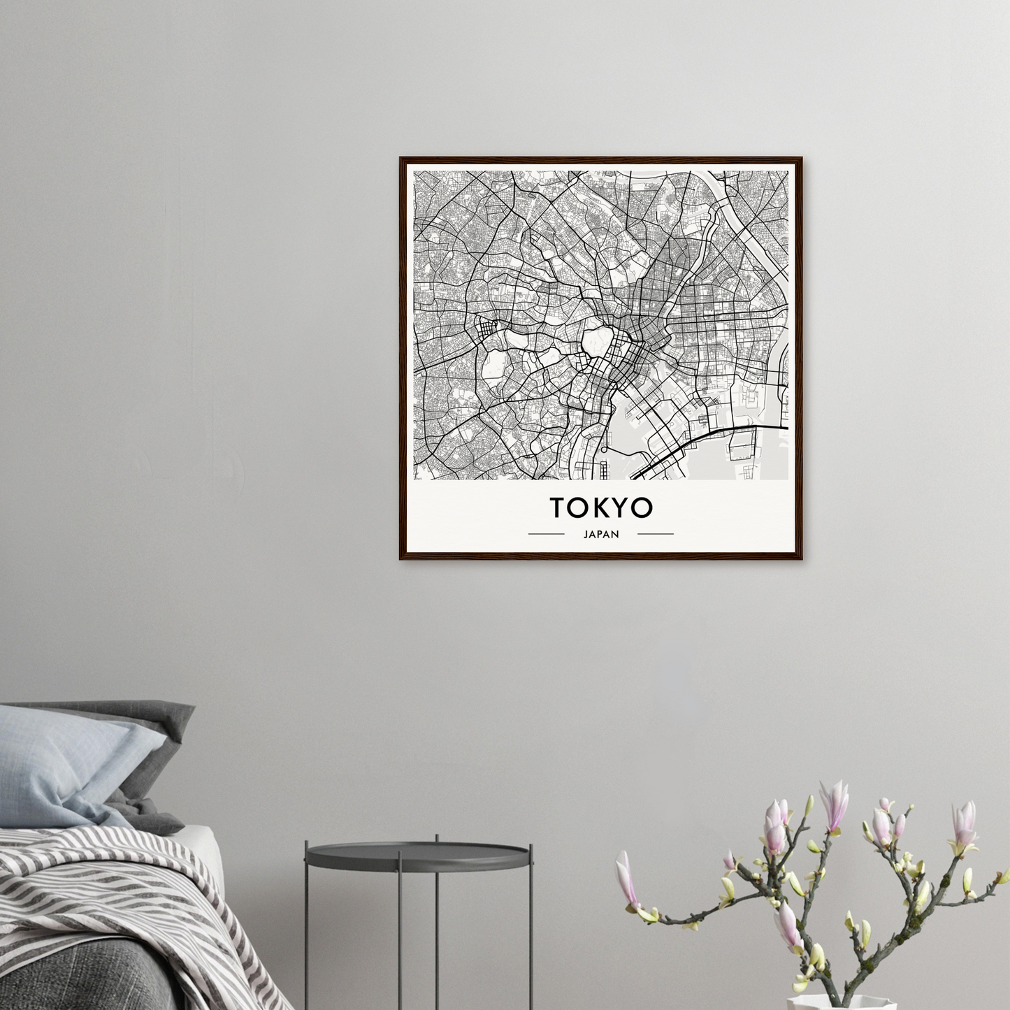 Framed map of Tokyo showing the city’s street layout and districts in black and white.
