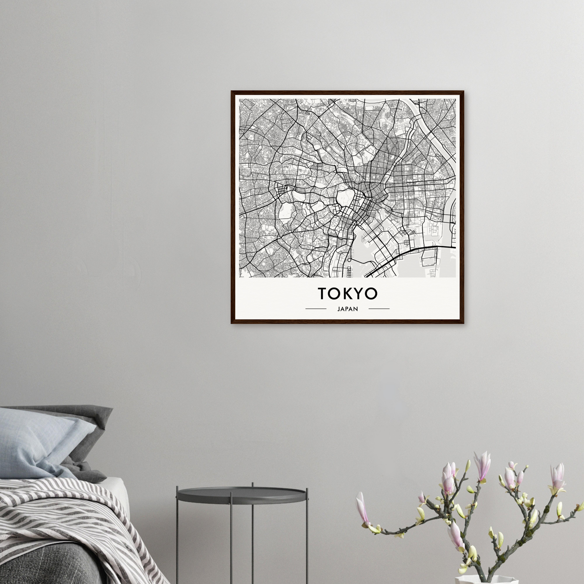 Framed map of Tokyo showing the city’s street layout and districts in black and white.