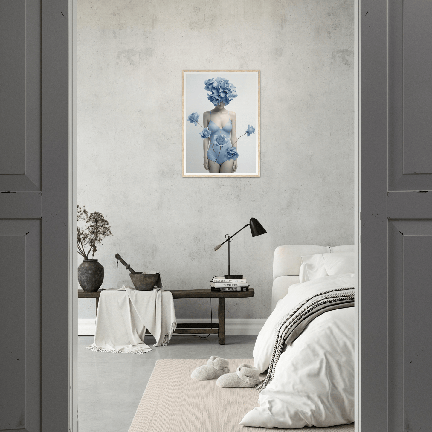Minimalist bedroom with a framed blue floral artwork as the focal point.