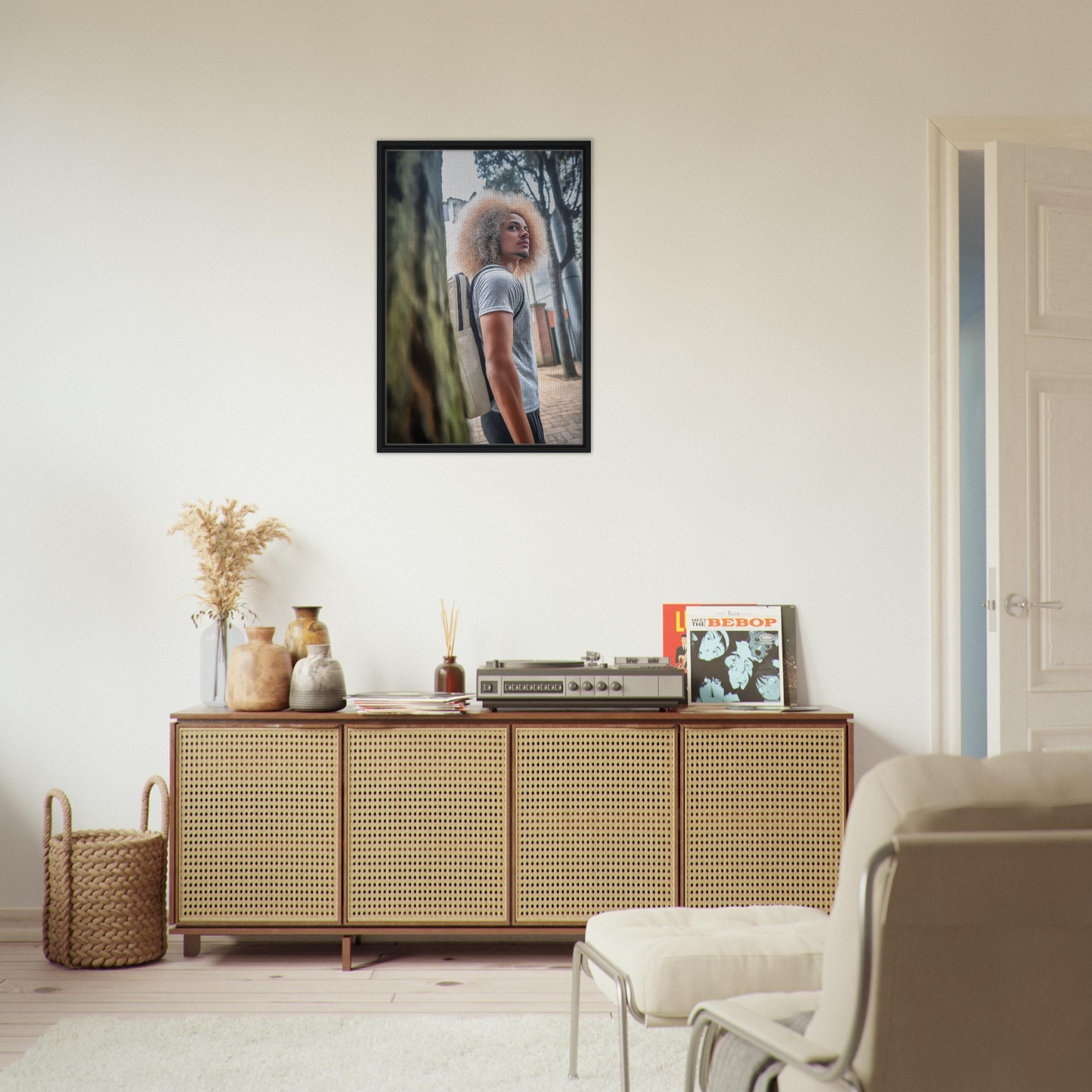 Rattan-fronted wooden sideboard with decorative items and framed canvas print from Urban Adventurous Gaze