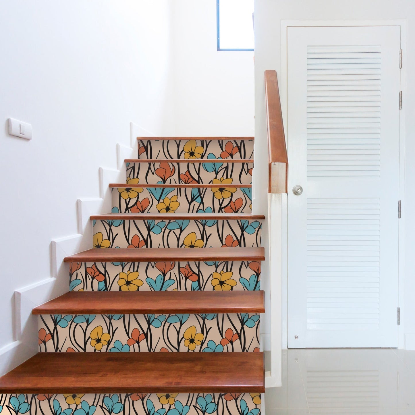 Staircase with decorative floral patterned risers and wooden treads.