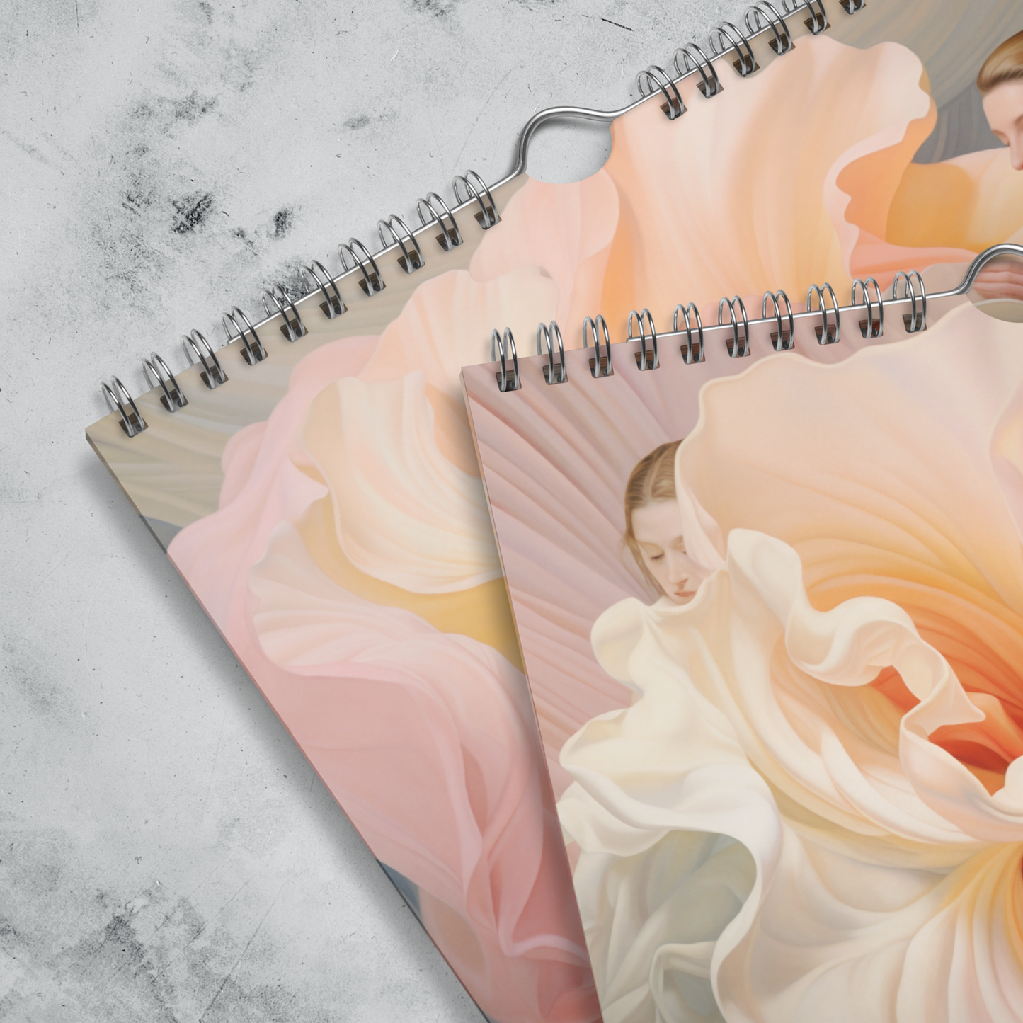 Spiral-bound notebooks with floral designs on the covers.