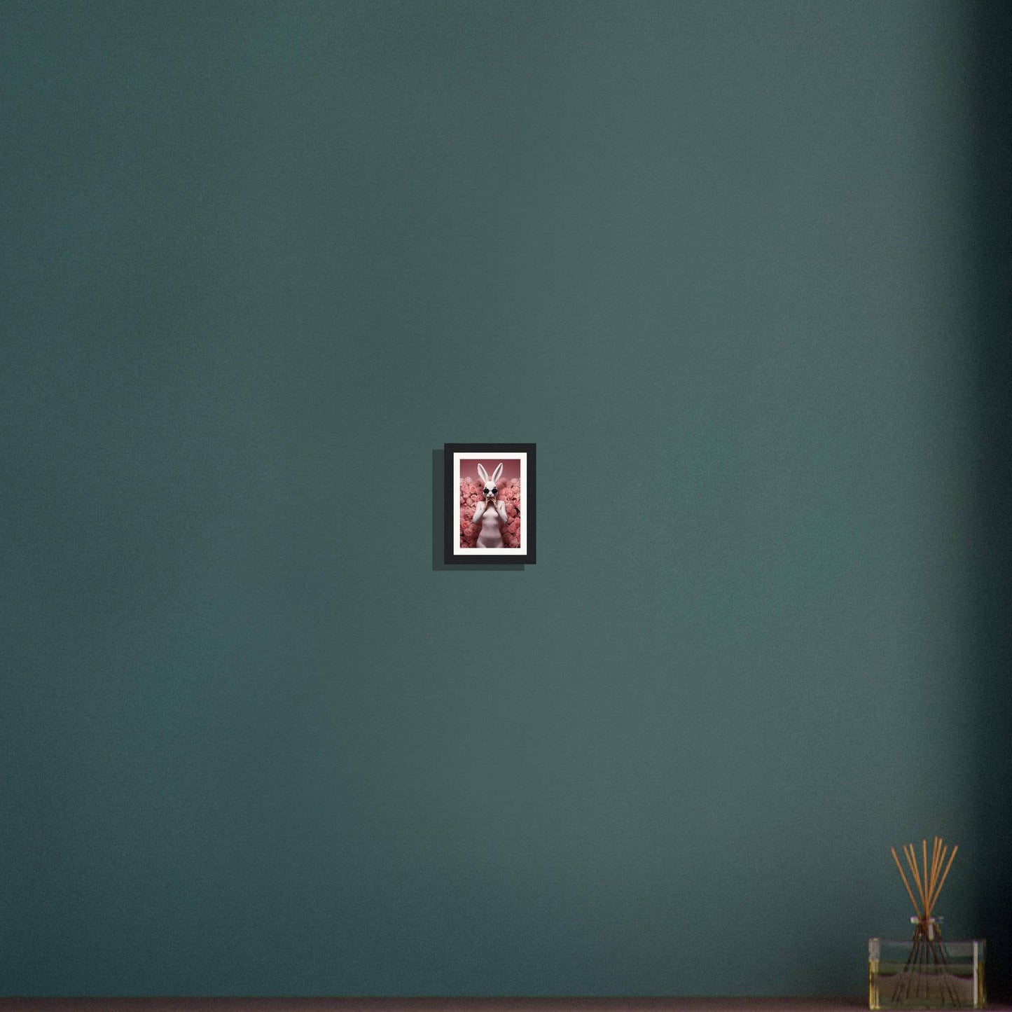 Framed artwork featuring a pink and white floral or abstract design against a dark background.